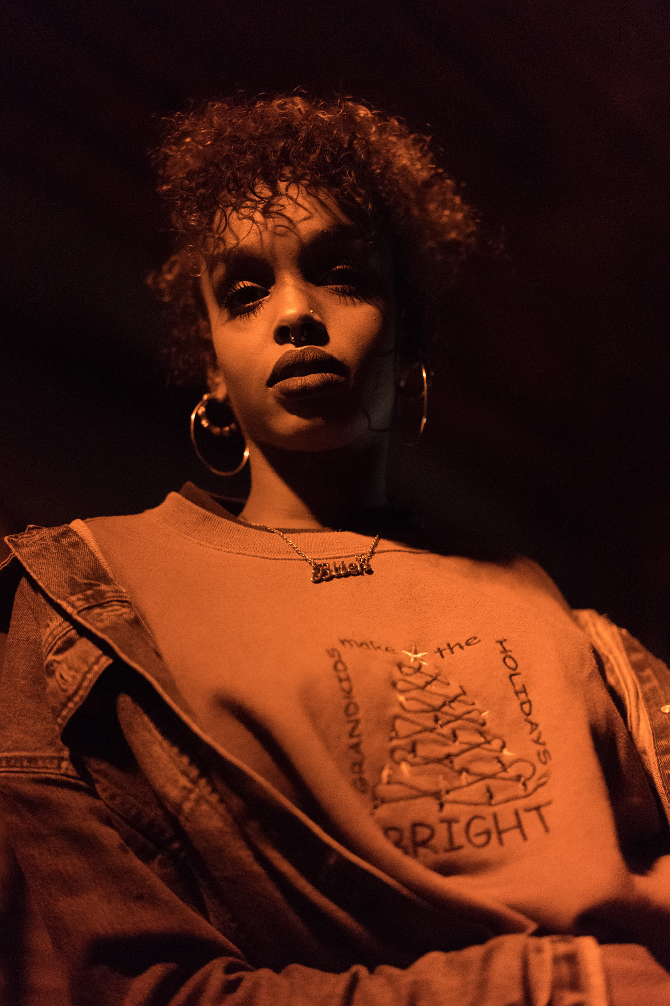 Low-light photo of a model looking down at the camera, Sony A9