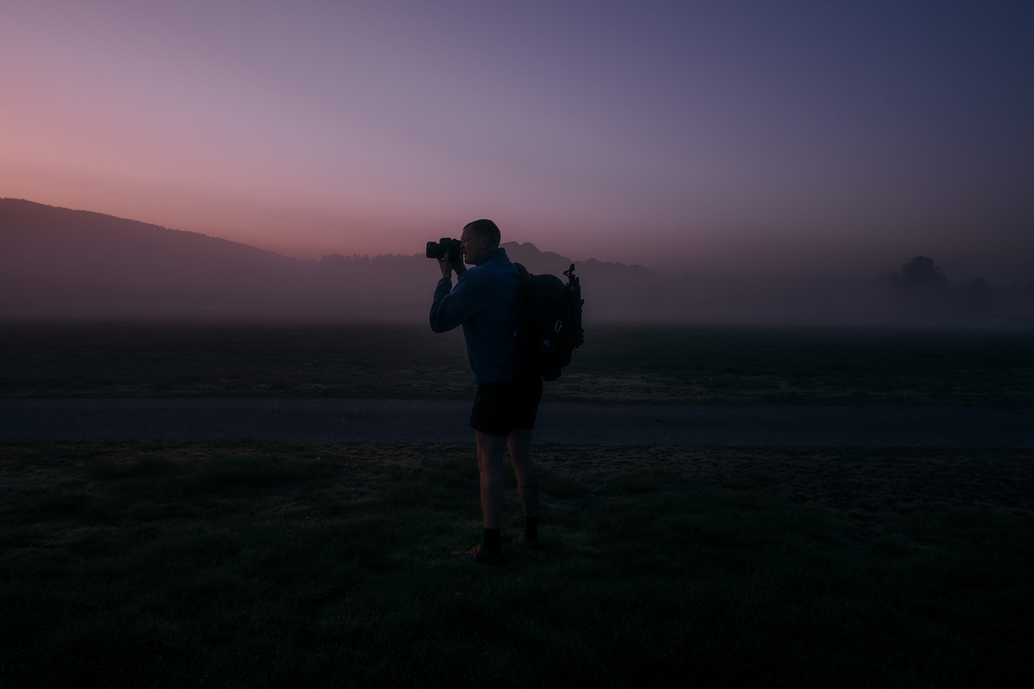 Homme prenant une photo au crépuscule