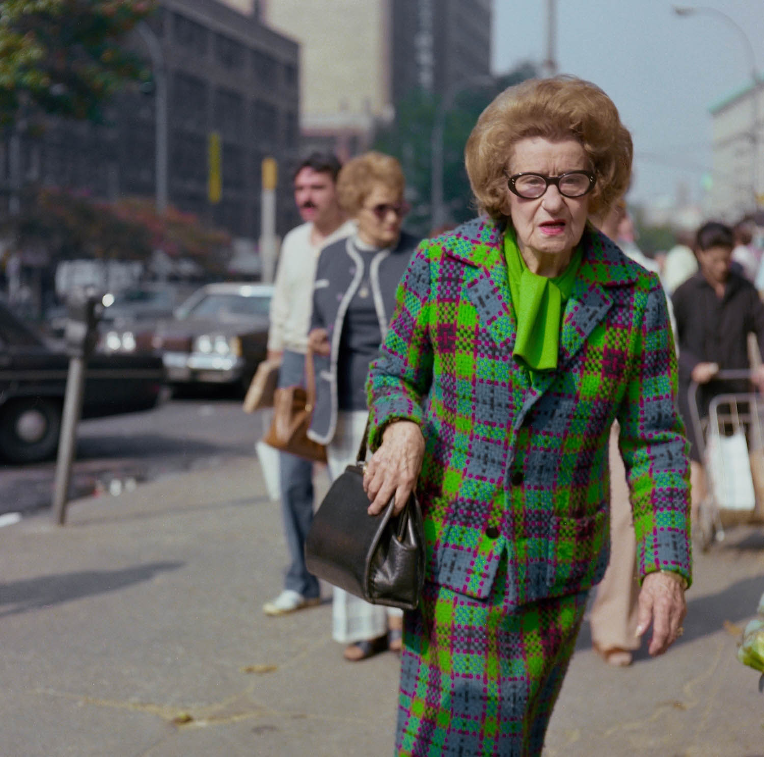 old lady with big brown hair in a green suit in the '70s