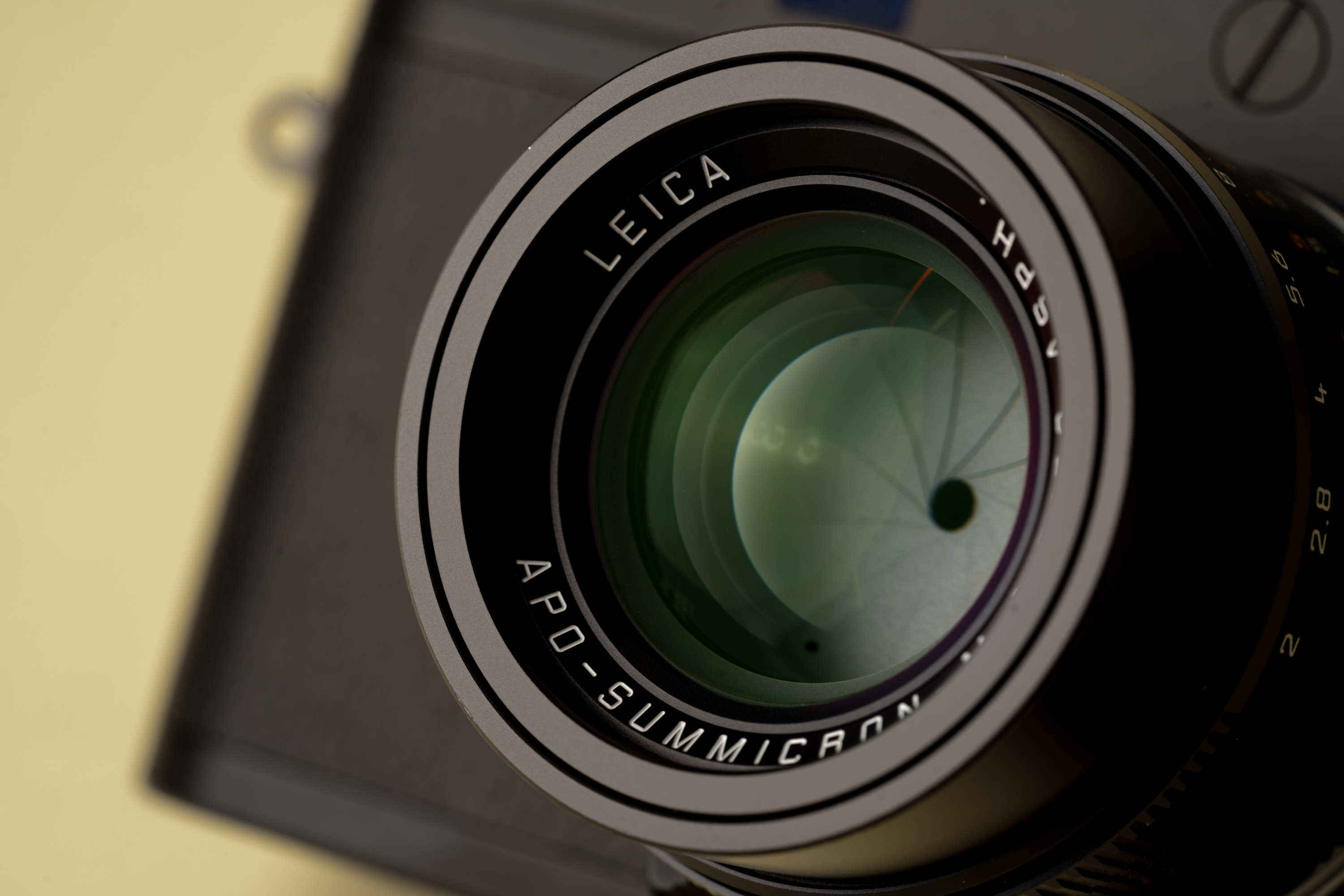 Eine Nahaufnahme der Blendenlamellen des Leica 50mm APO-Summicron ASPH f/2, aufgenommen vor einem cremefarbenen Hintergrund
