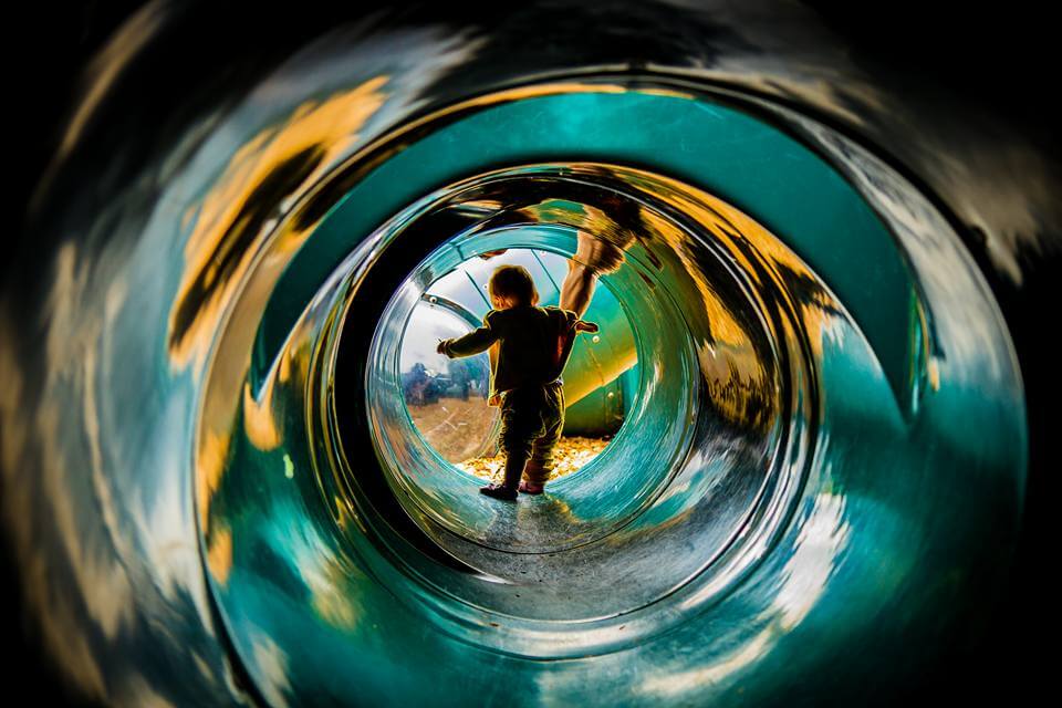 Young child in a playground tunnel