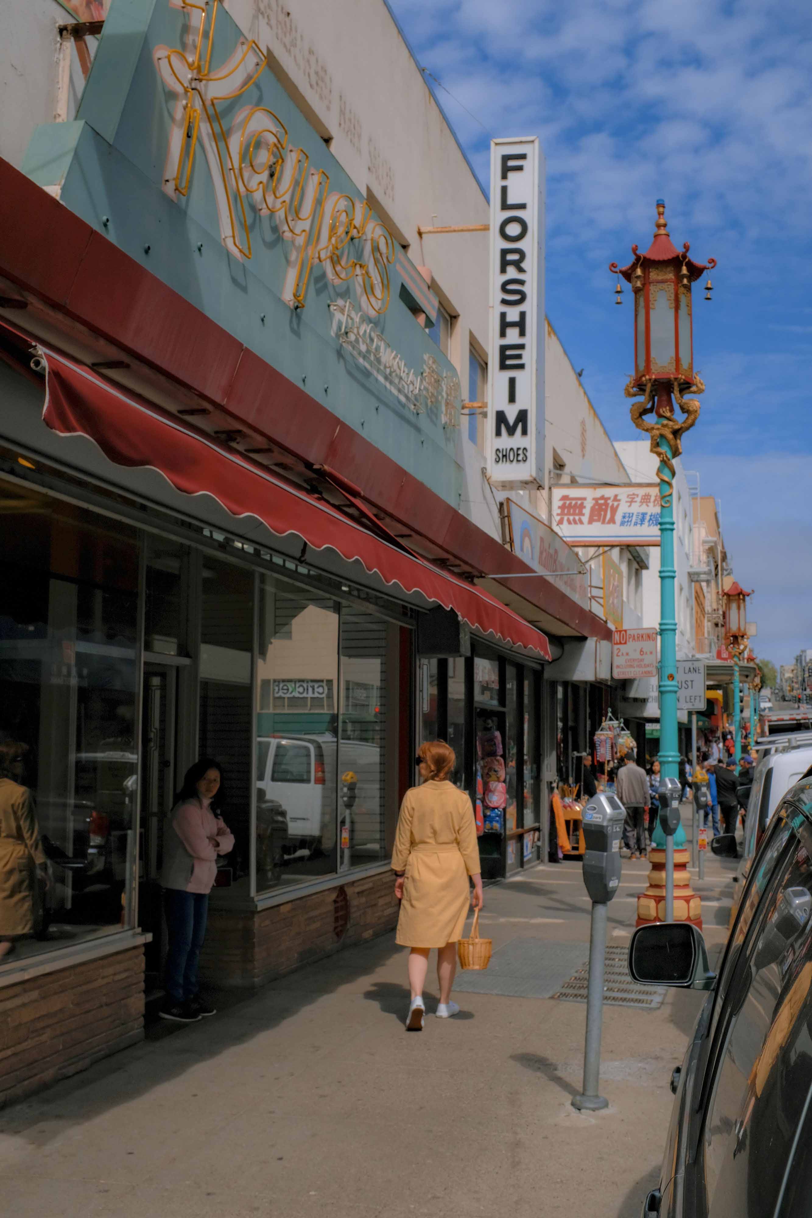 American street scene with a woman wearing an orange dress. Image by Josh Edgoose.