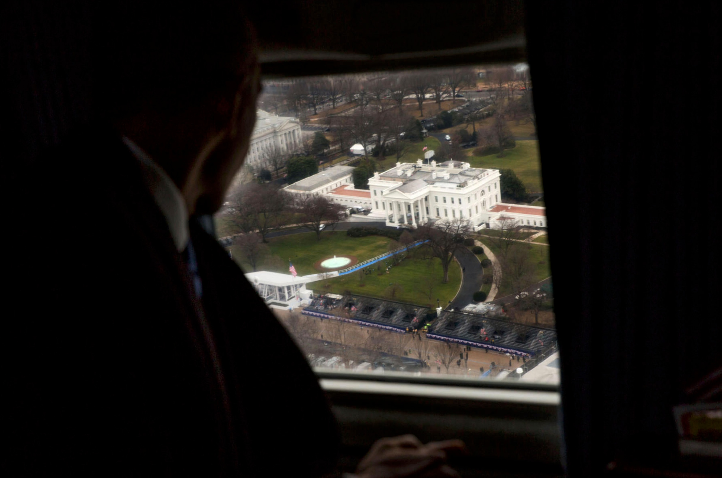 President Barack Obama looking out at the White House from a helicopter window