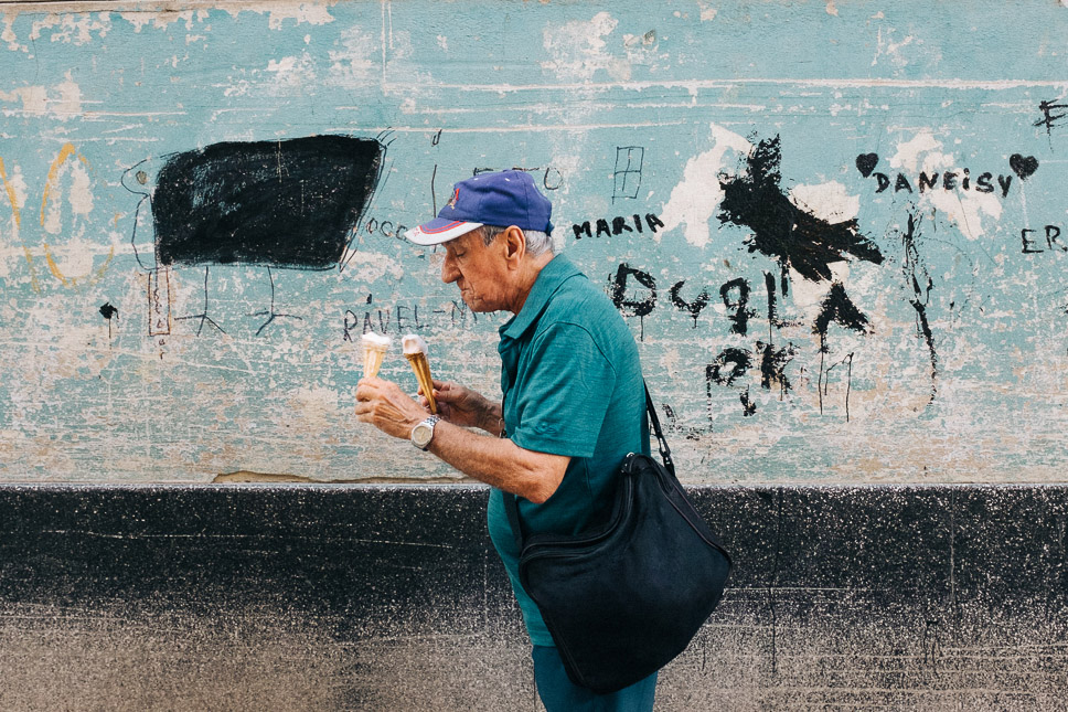 A man holding two ice creams while walking. Taken on the Fujifilm X100T by Ian Howorth.