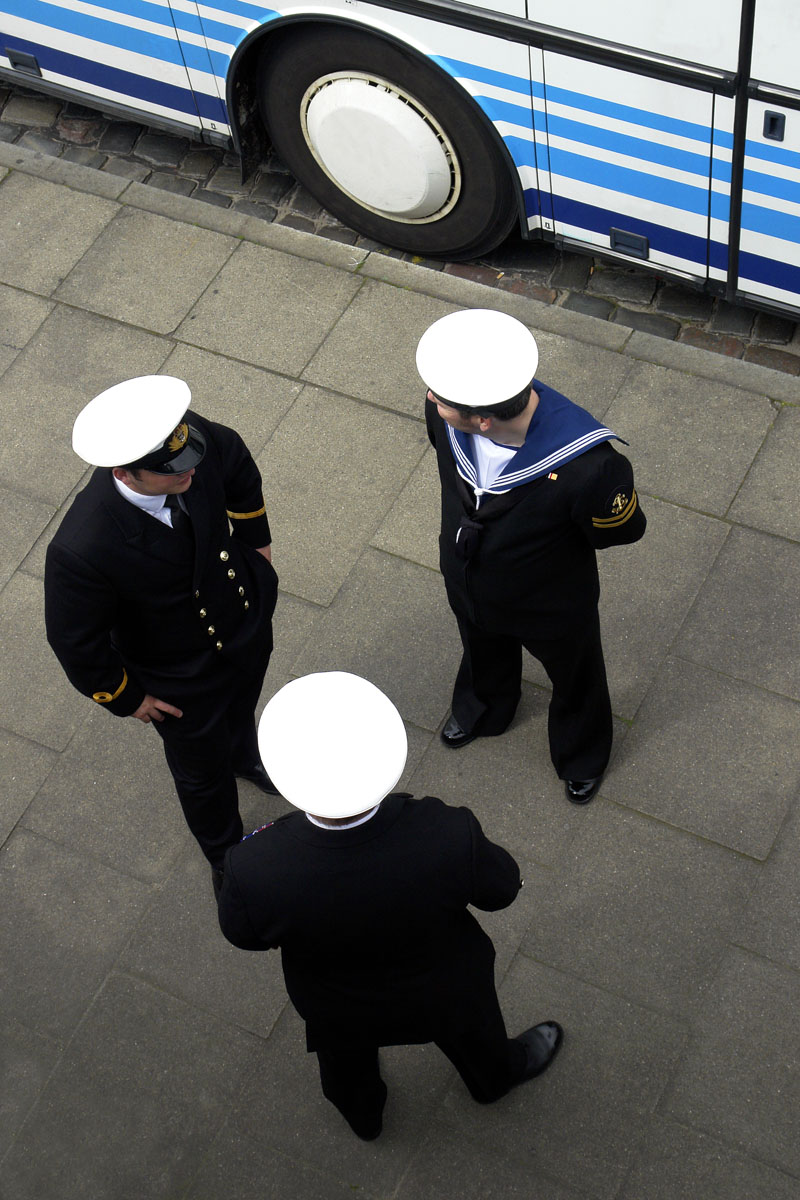Three sailors on the street photographed from above