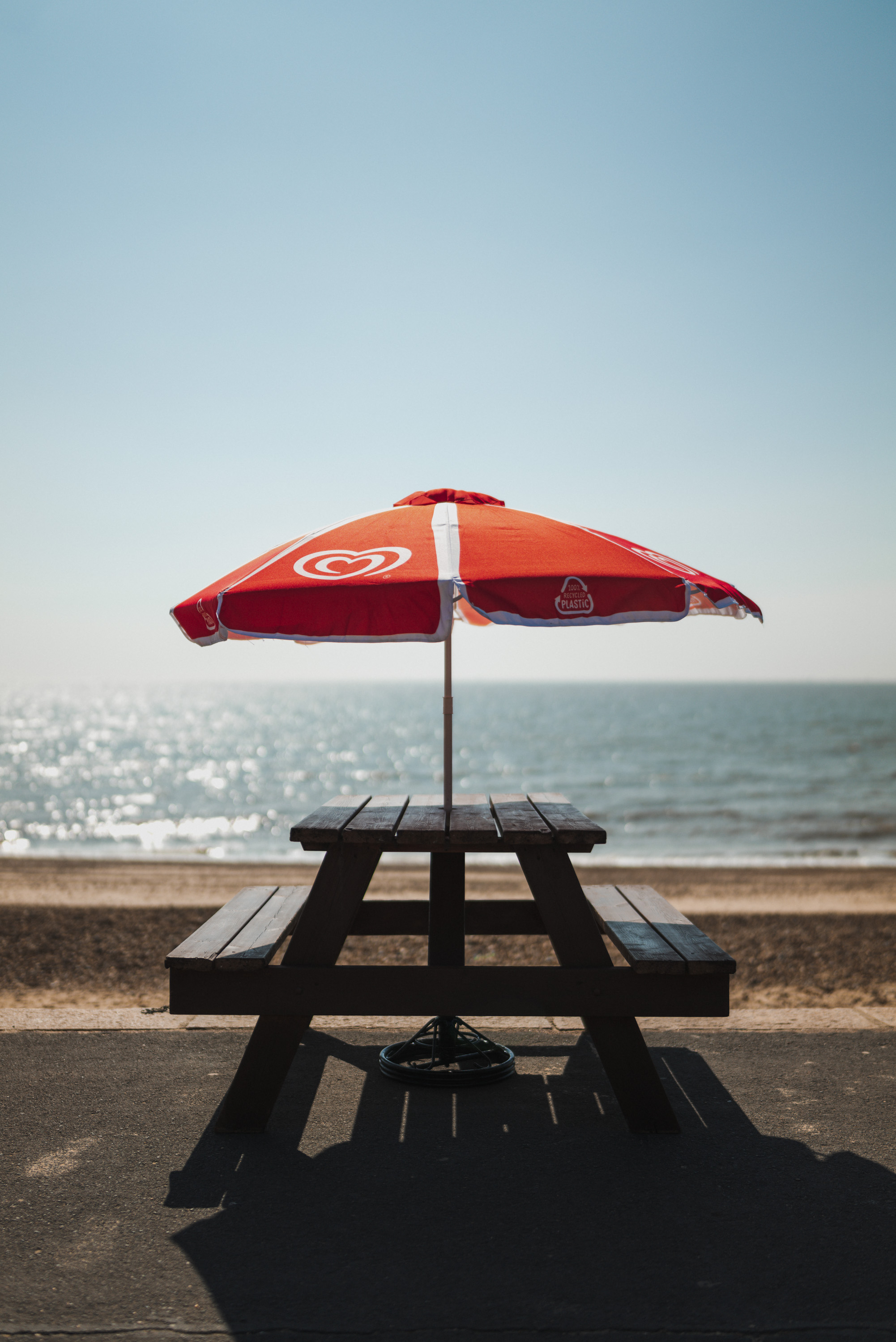 Picnic bench and parasol at the beach, by Ian Howorth with Leica SL2 and Sigma 35mm f/1.2 DG DN ART