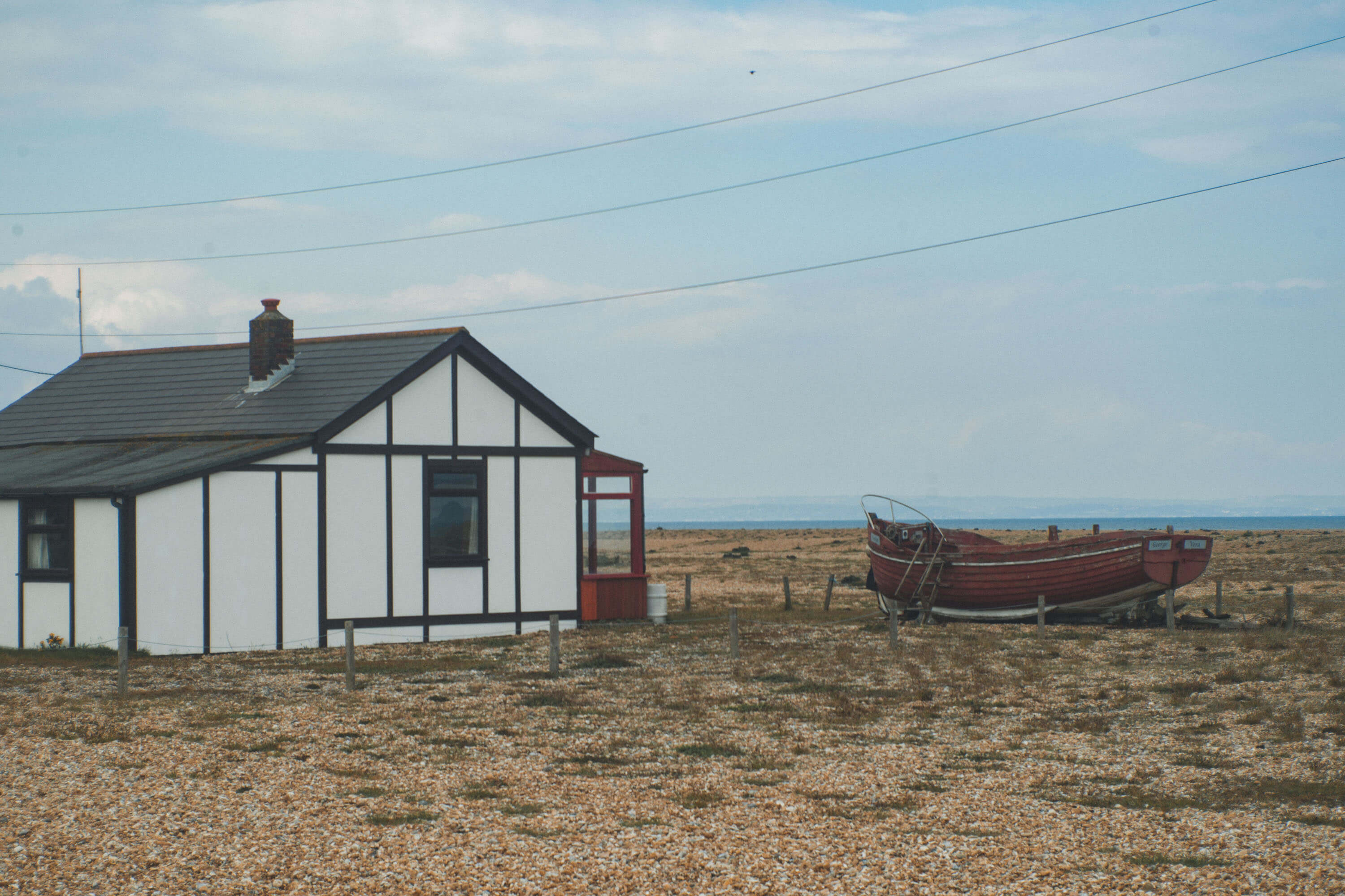 Beach house with boat outside