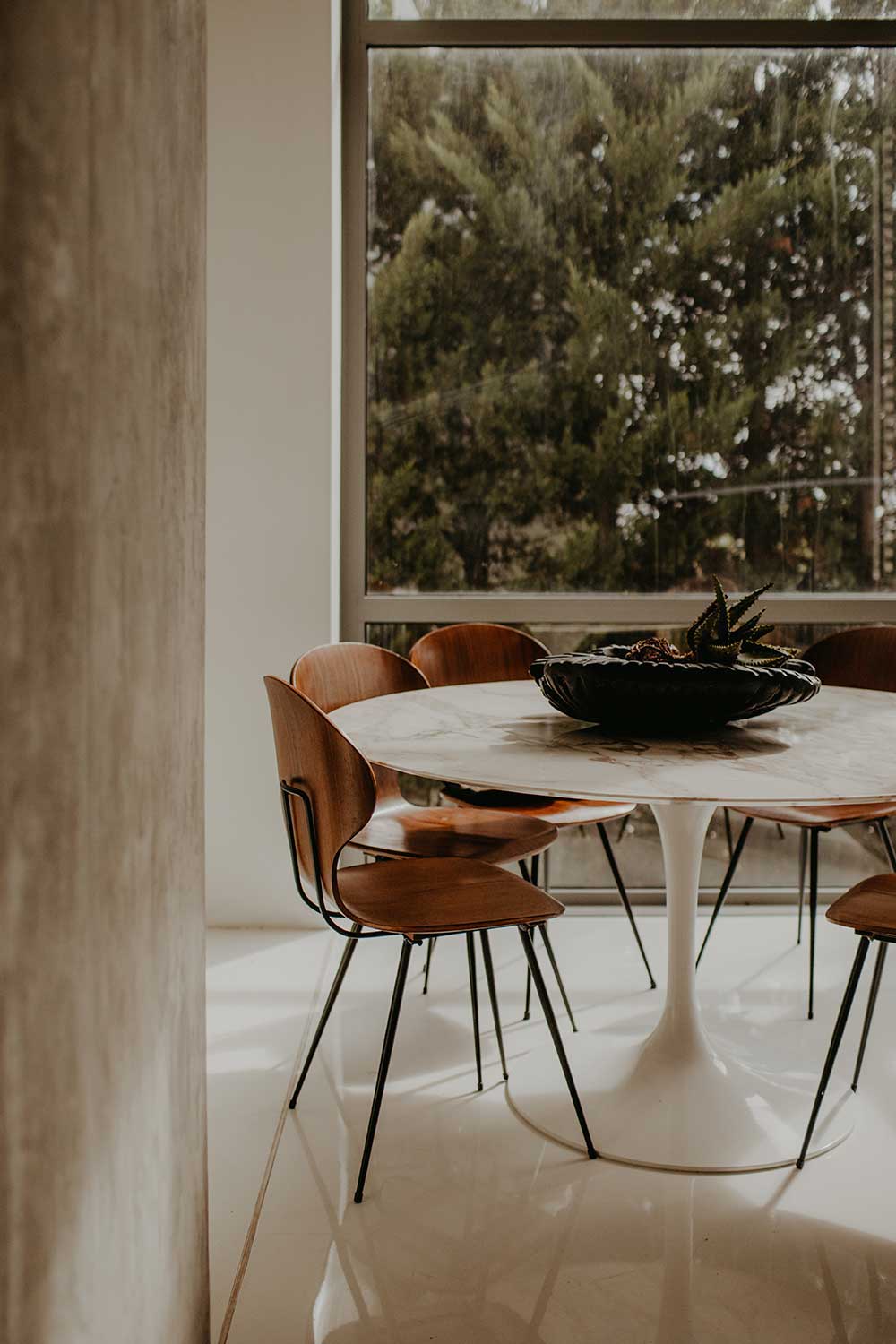 Interior of a dining room, round table with orange chairs