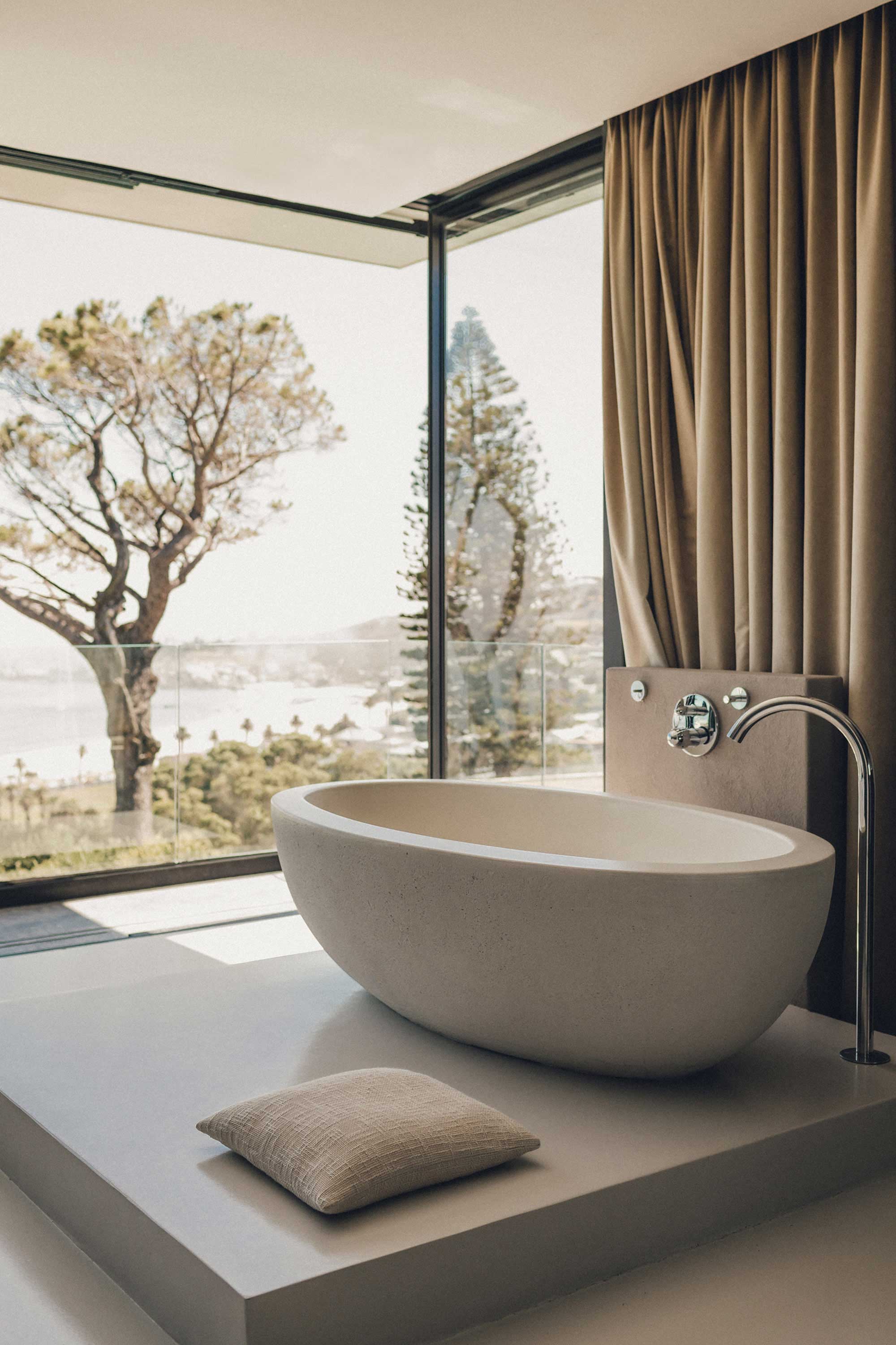 Photo of bathtub with window and tree
