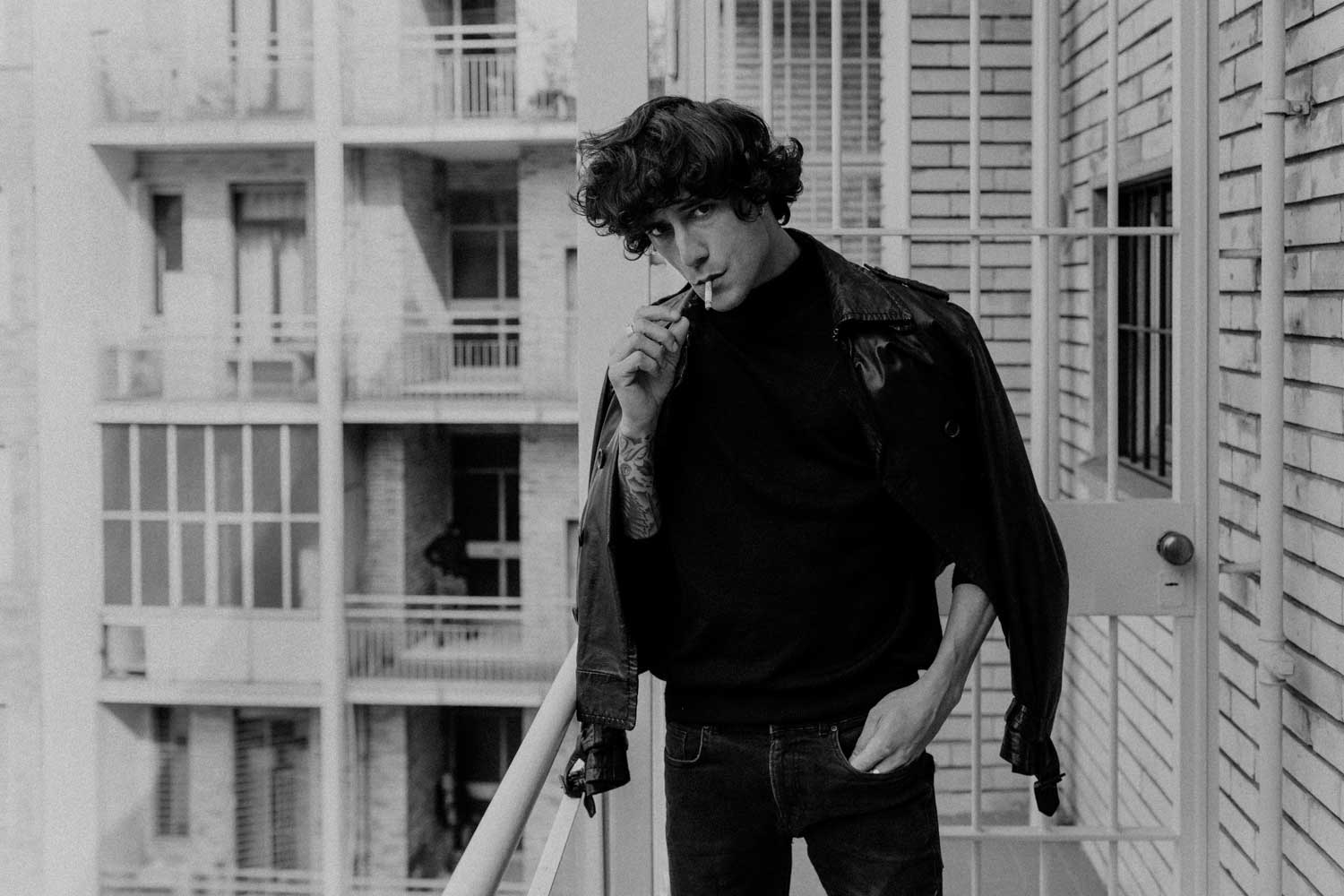 Black and white photo of person smoking a cigarette