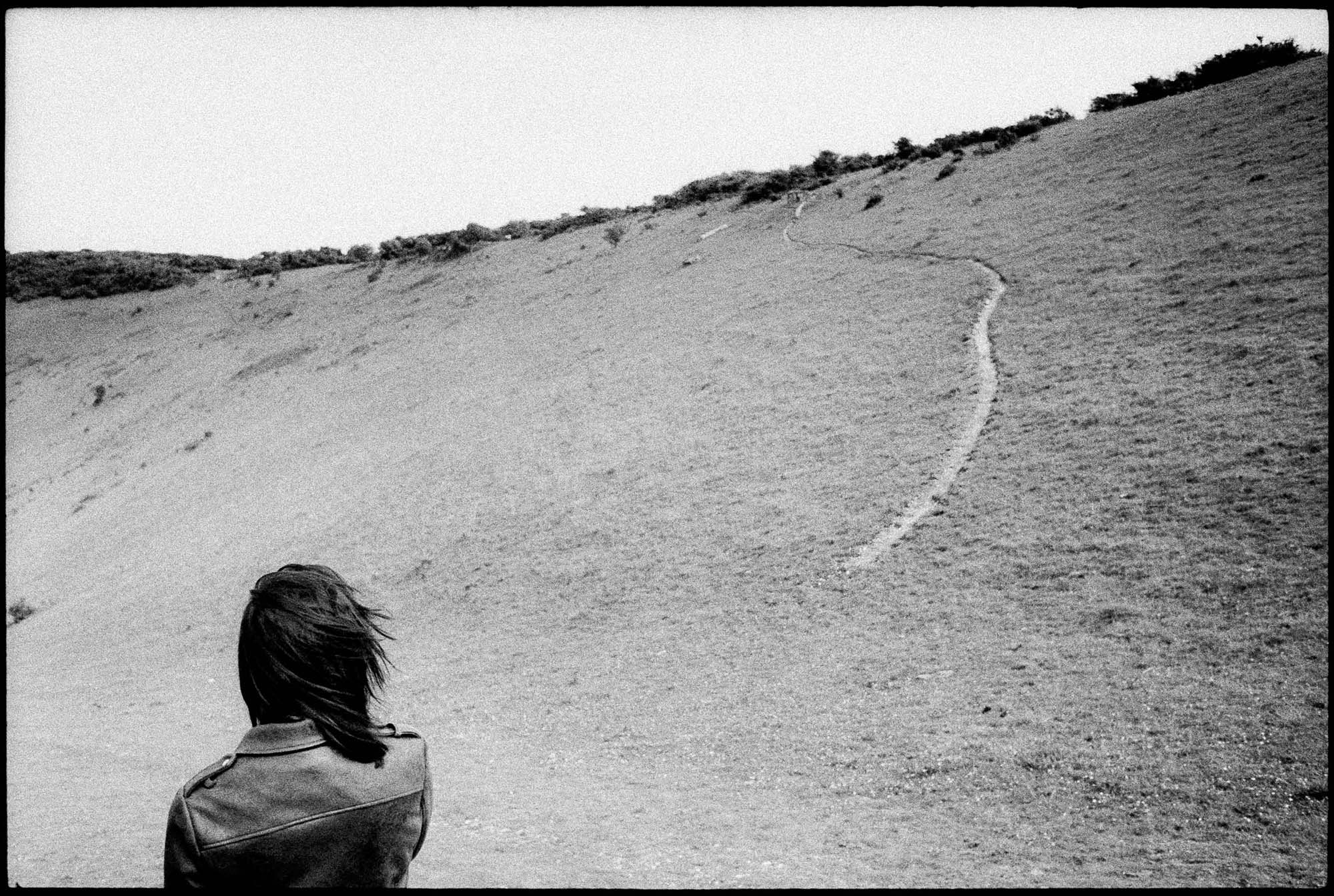 Woman looking at a sand dune- black-and-white
