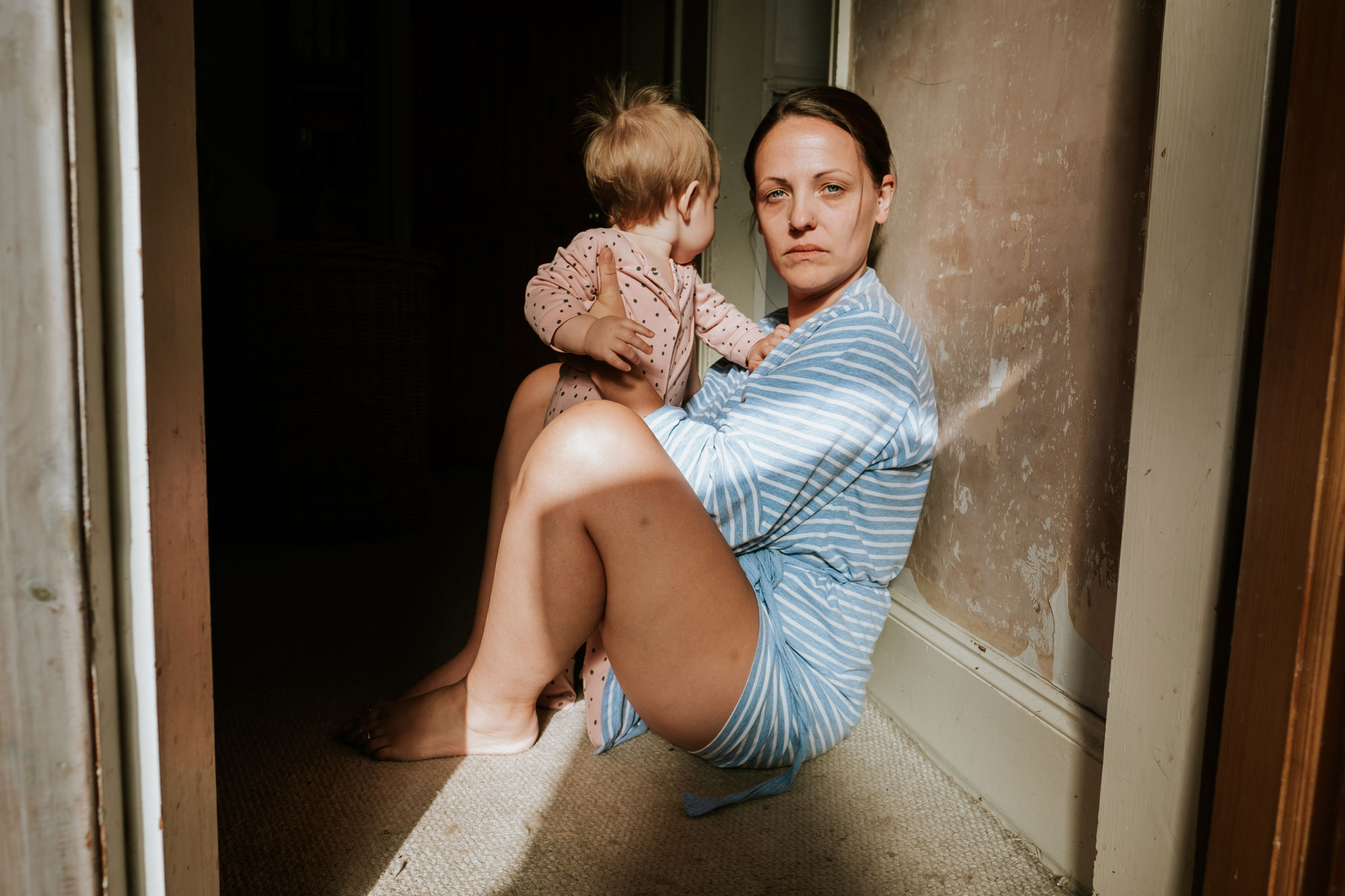 Portrait of mother with her child in a hallway 