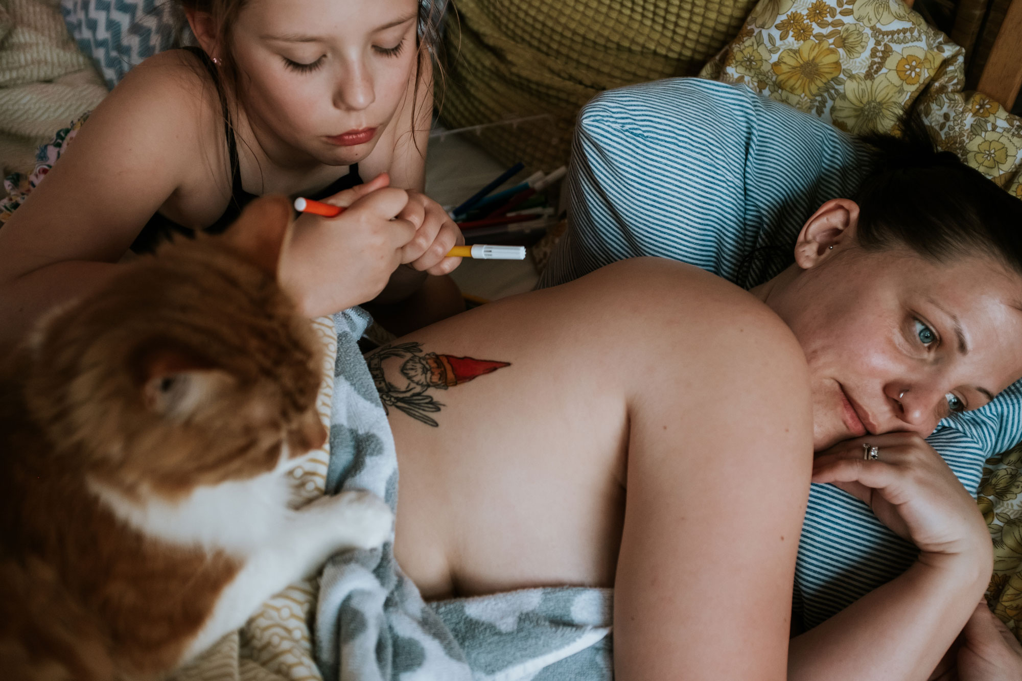 Mother and child lie in bed together