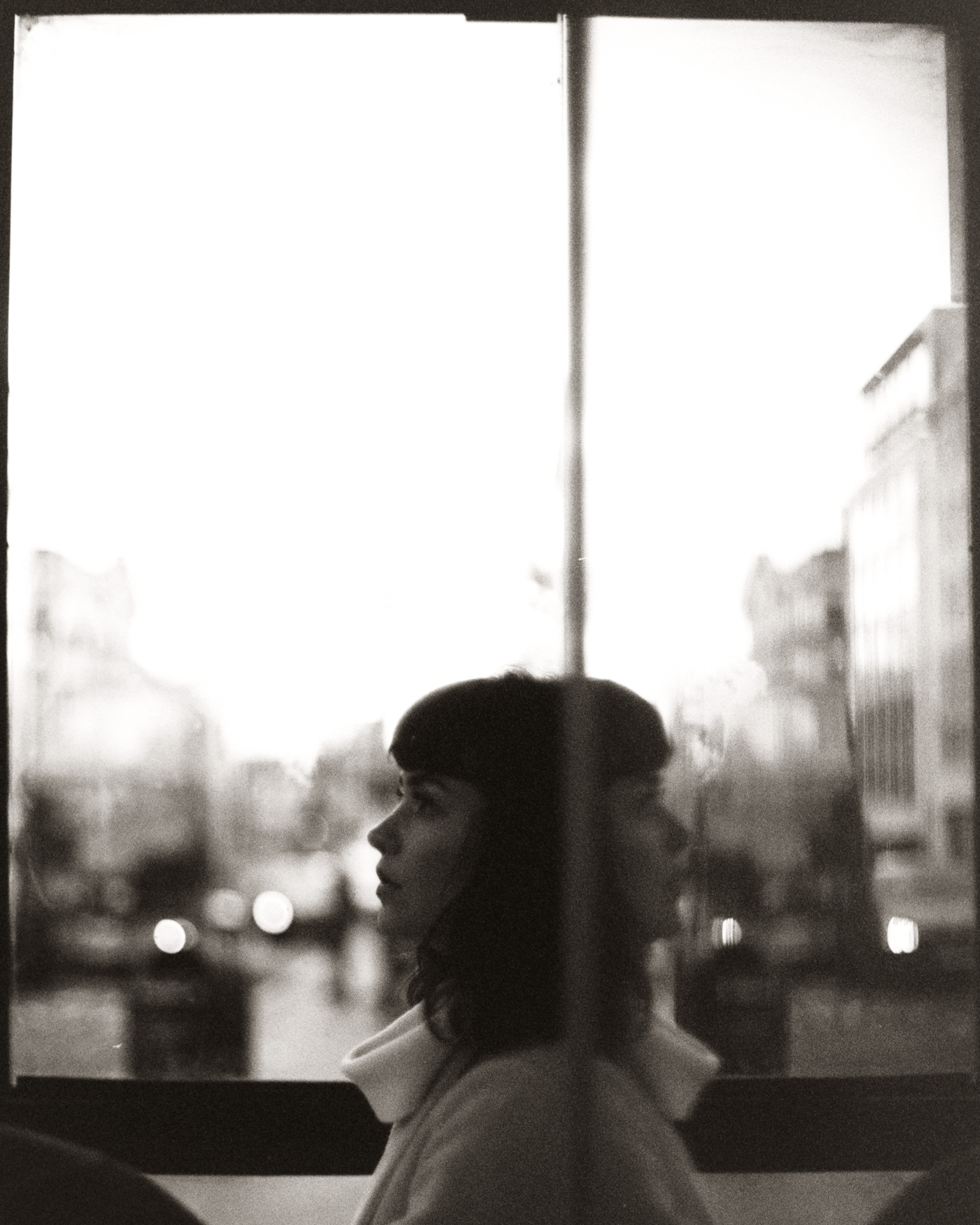 Woman sitting near window