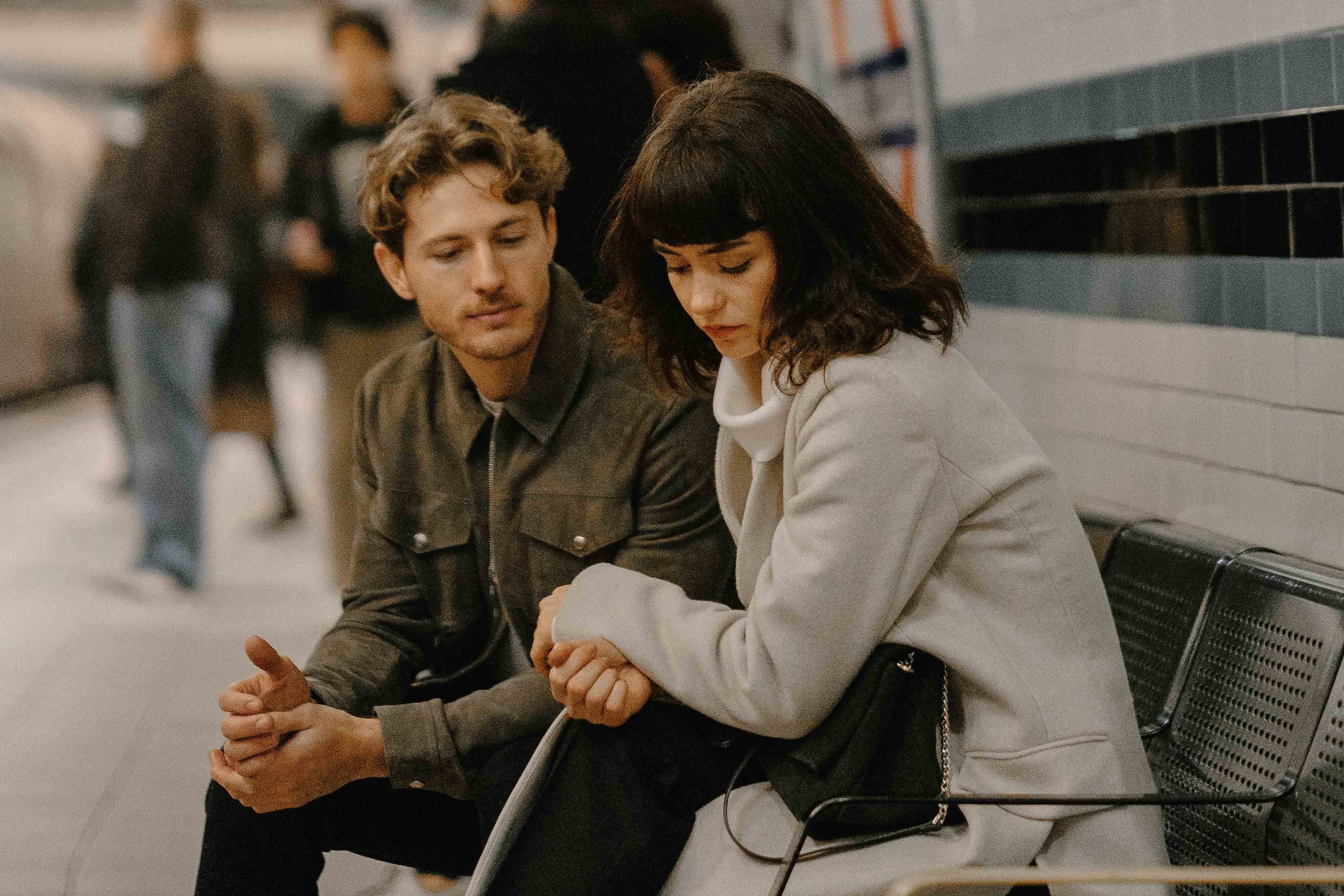 couple sitting at tube station