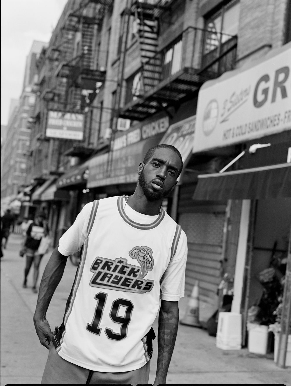 Candid picture of a person wearing a basketball top in the street