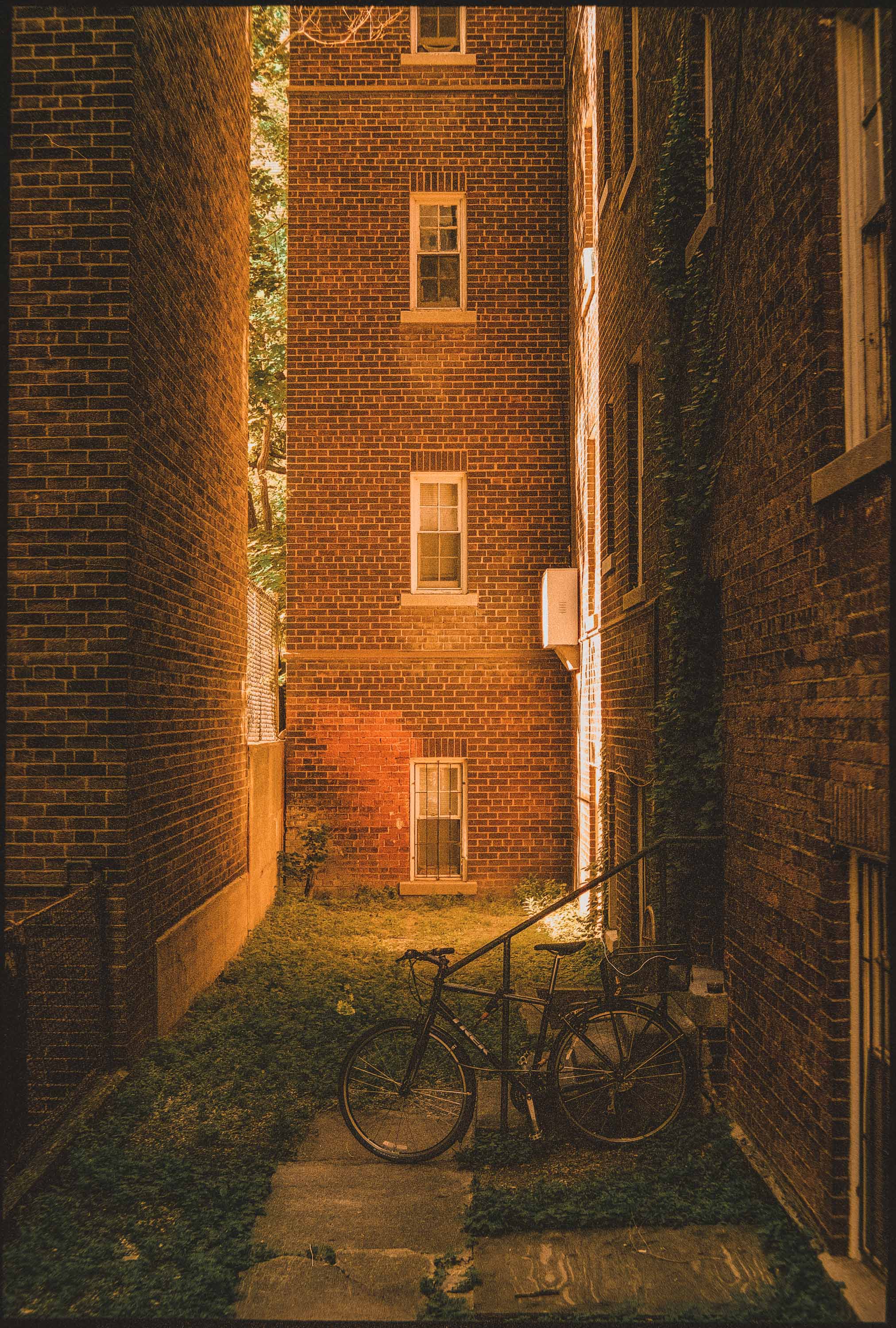 Tall brick building bathed in warm orange-yellow sunlight