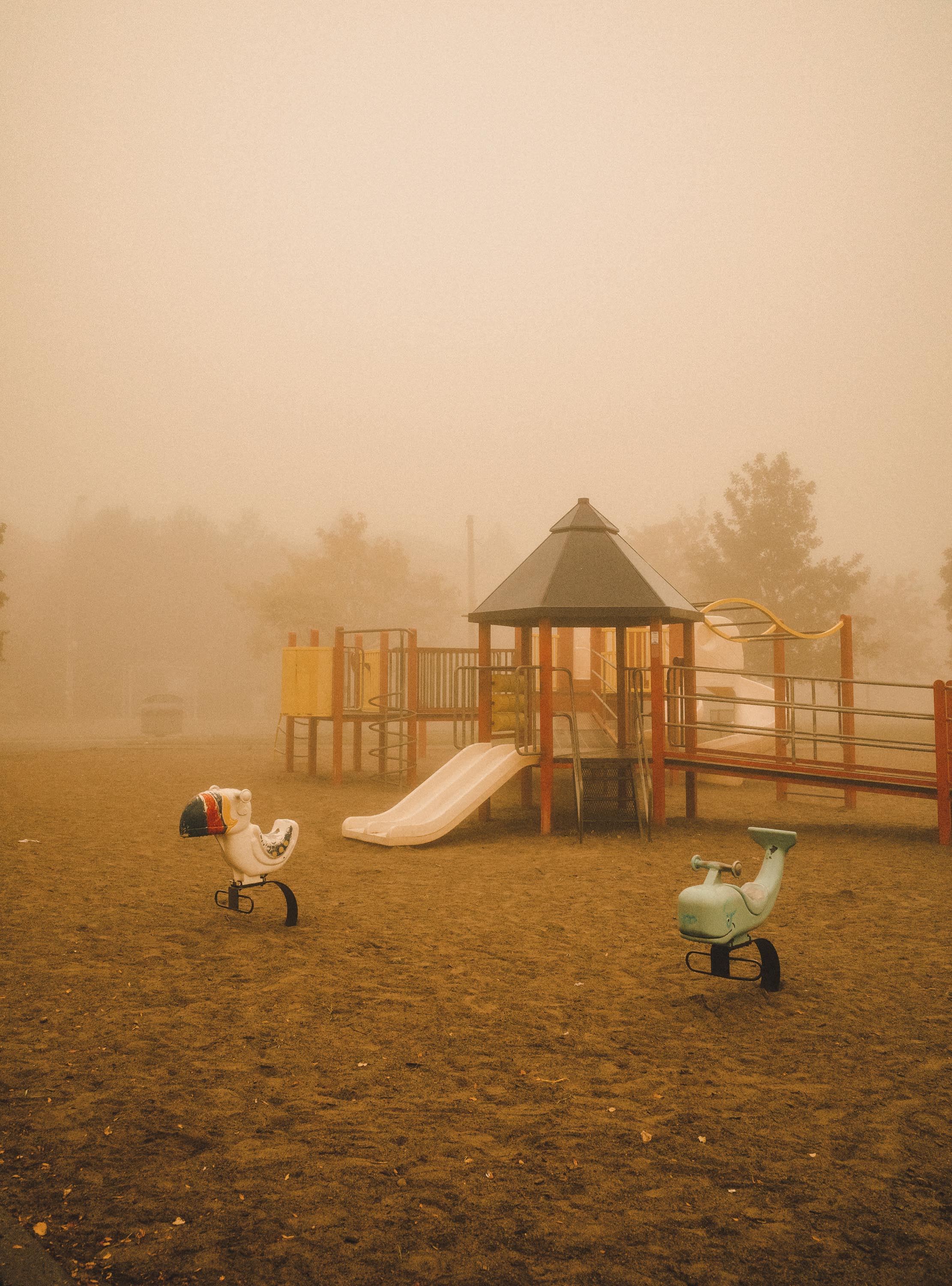 Children's playground in a brownish fog