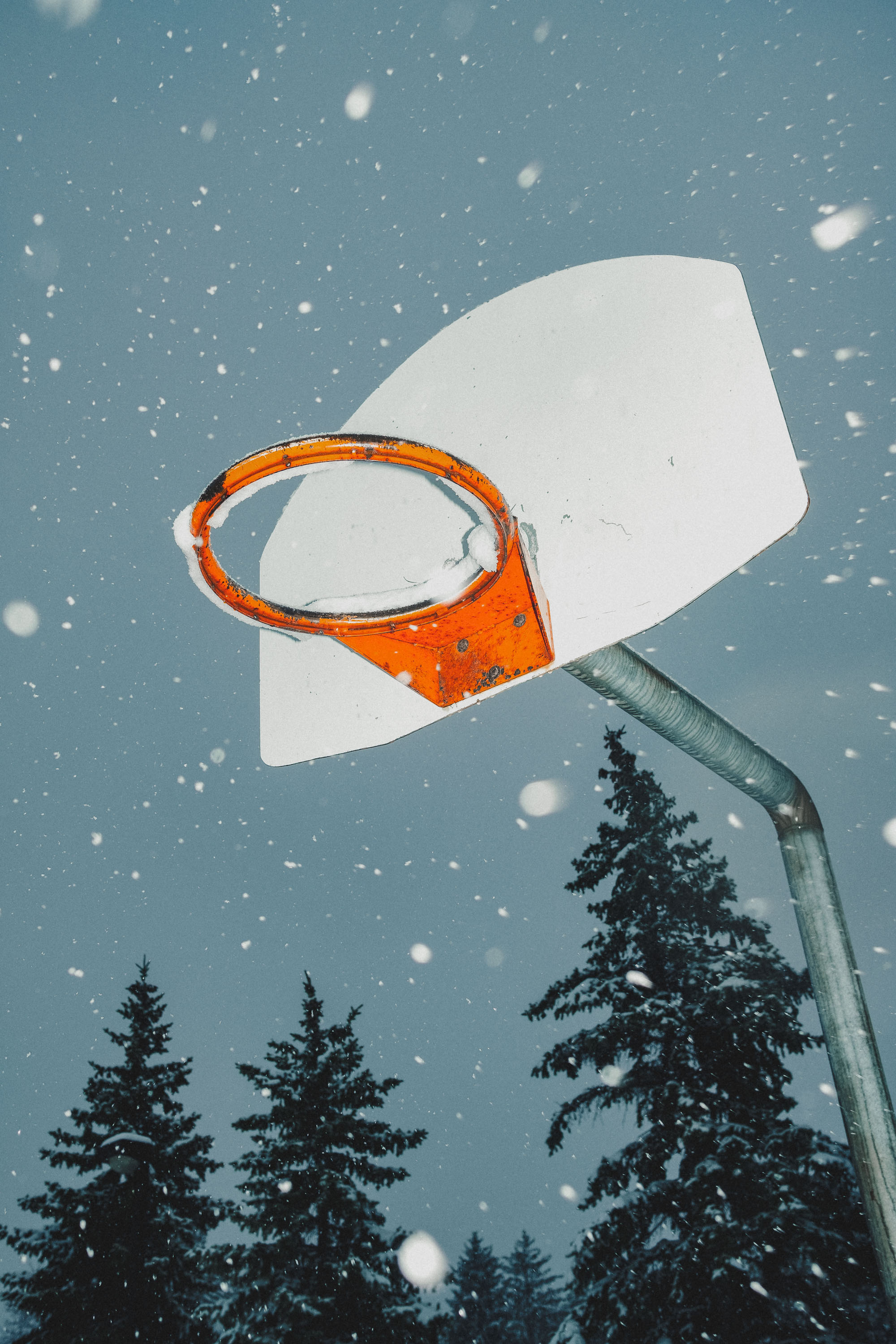 Flash illuminated basketball hoop in the snow
