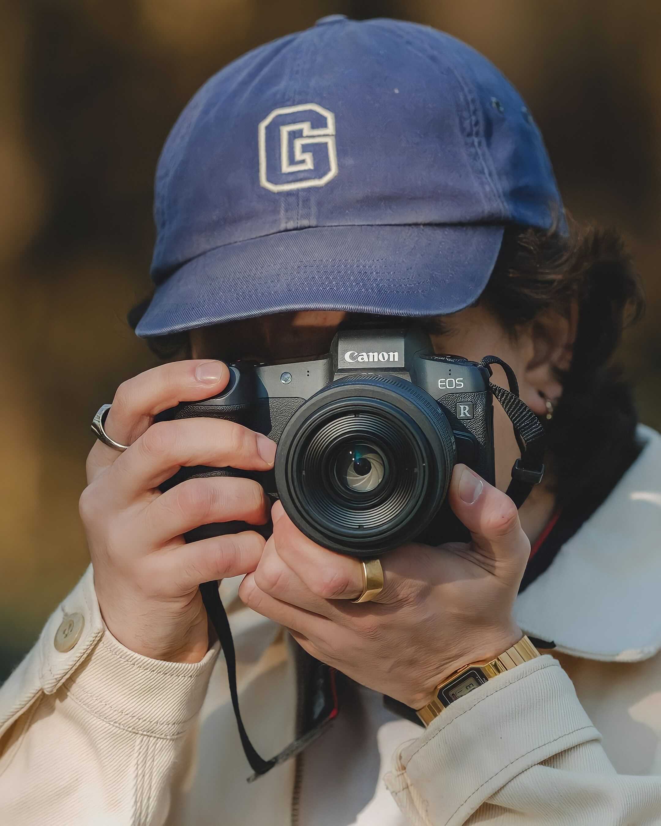 A person taking a picture with a Canon EOS R