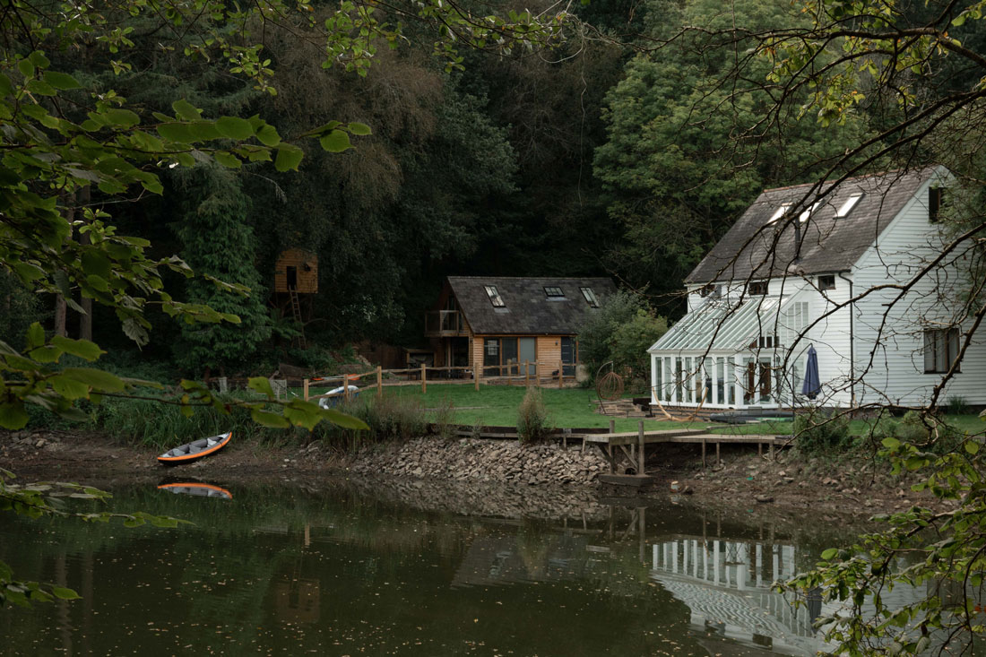 White house in the woods by a small lake