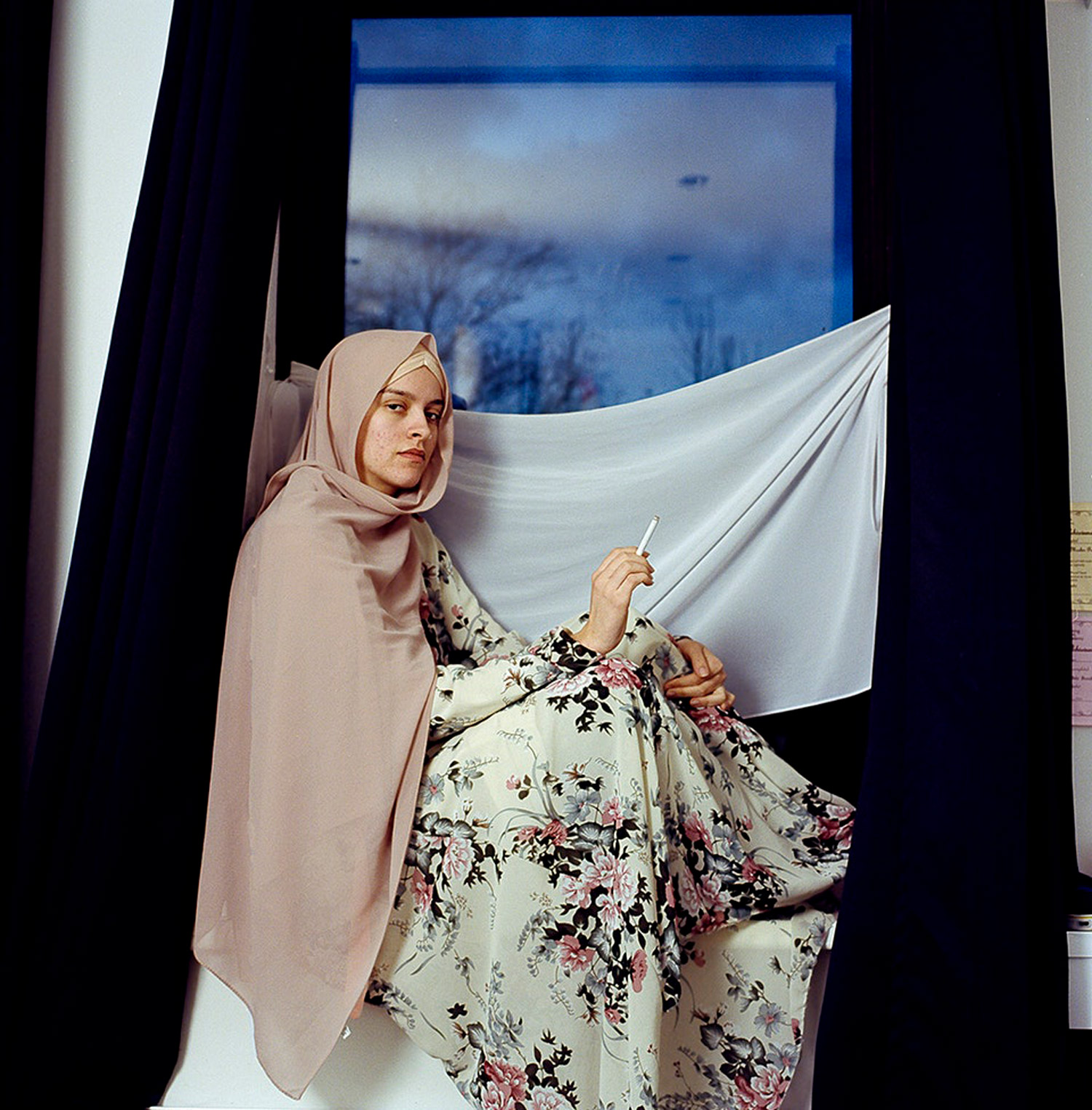Woman posing for a portrait with a cigarette in hand. Jodie Bateman @jodiembateman.