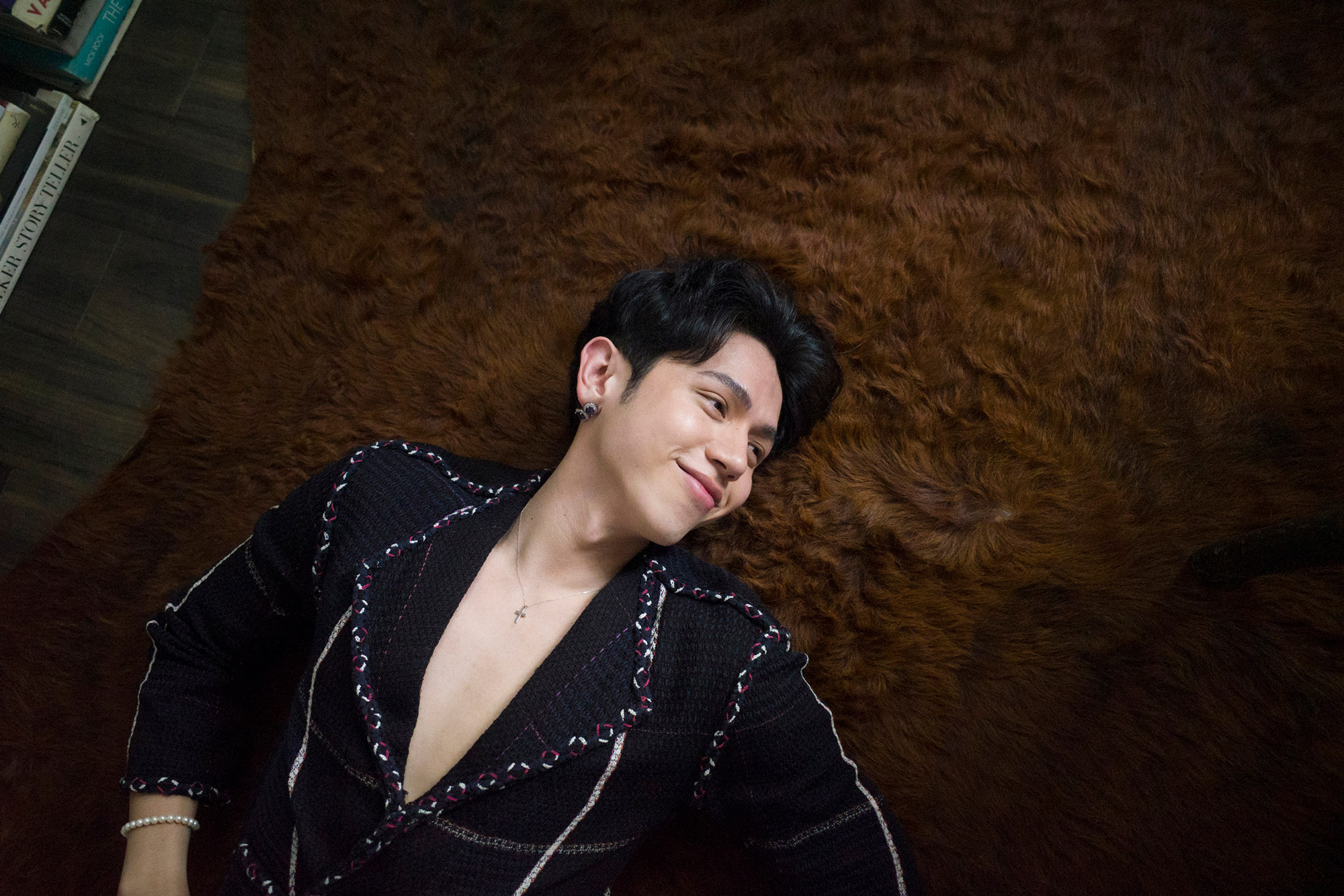 A Person laying on a carpet smiling. Shot by Regine David.  