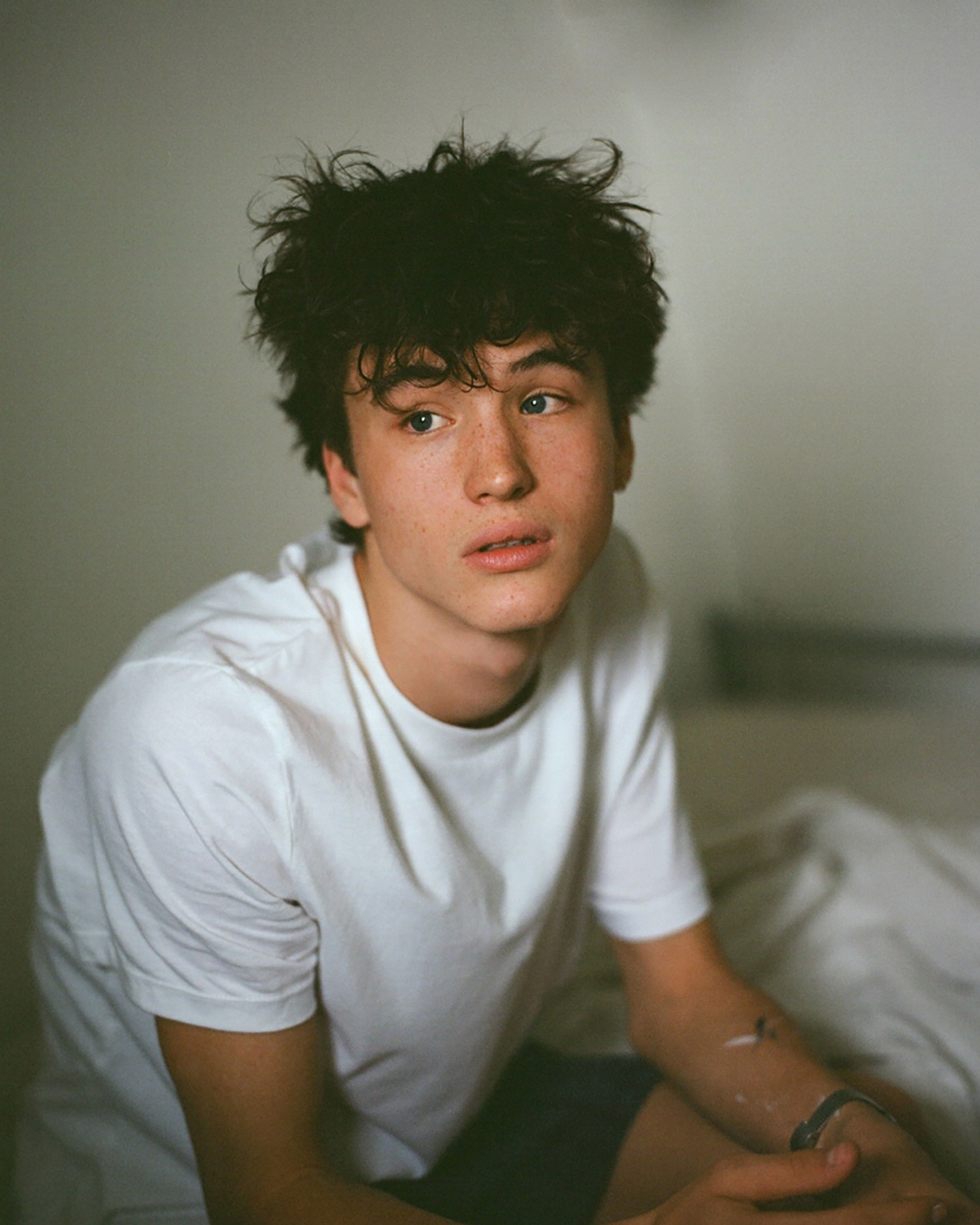 Portrait of a young person on a bed 