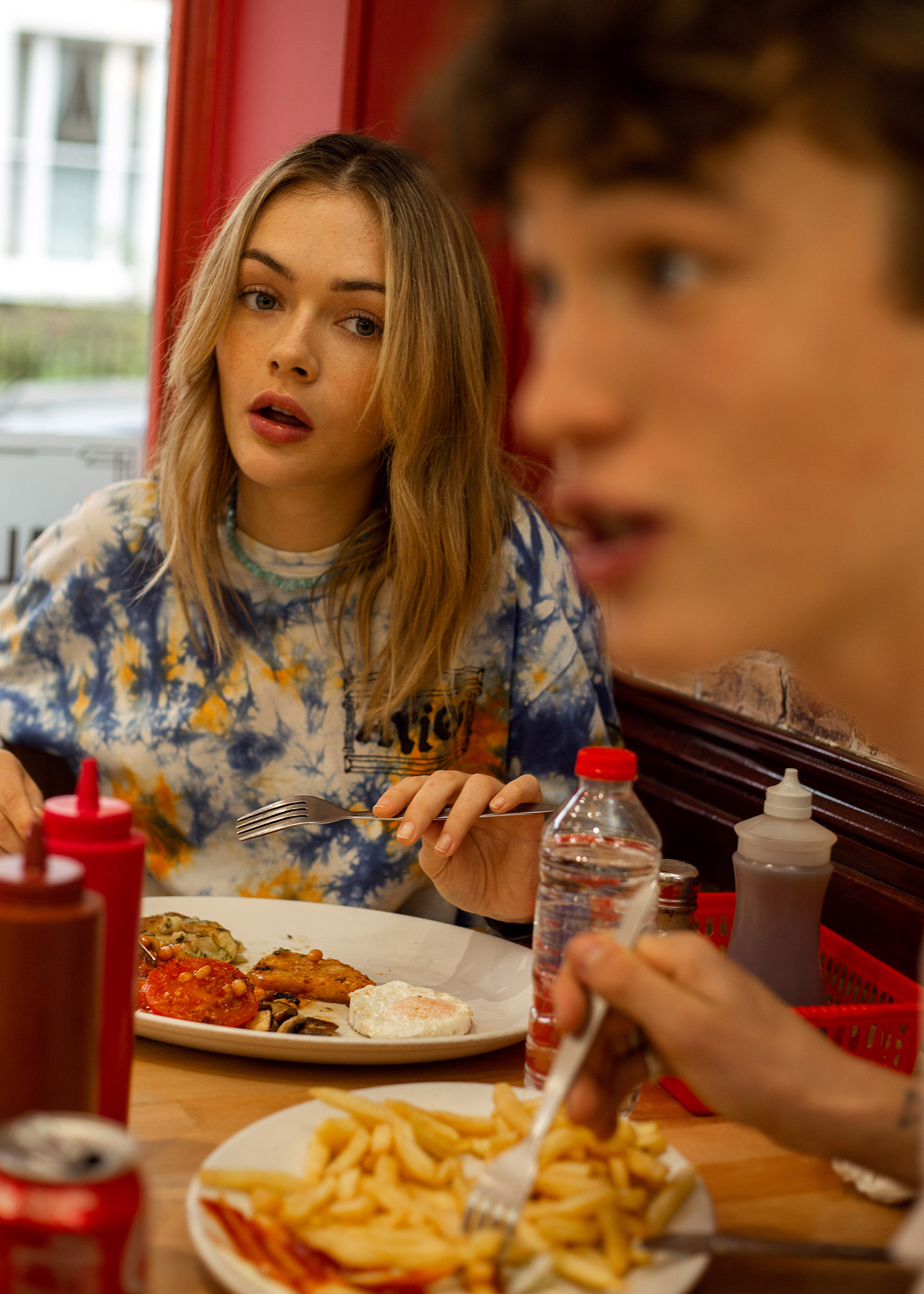 Person looking surprised at another person at the diner 