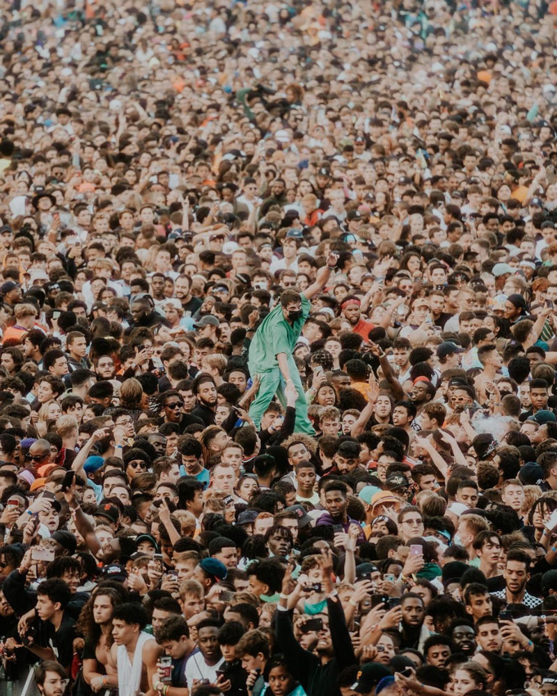 Performer crowd surfs in a large crowd
