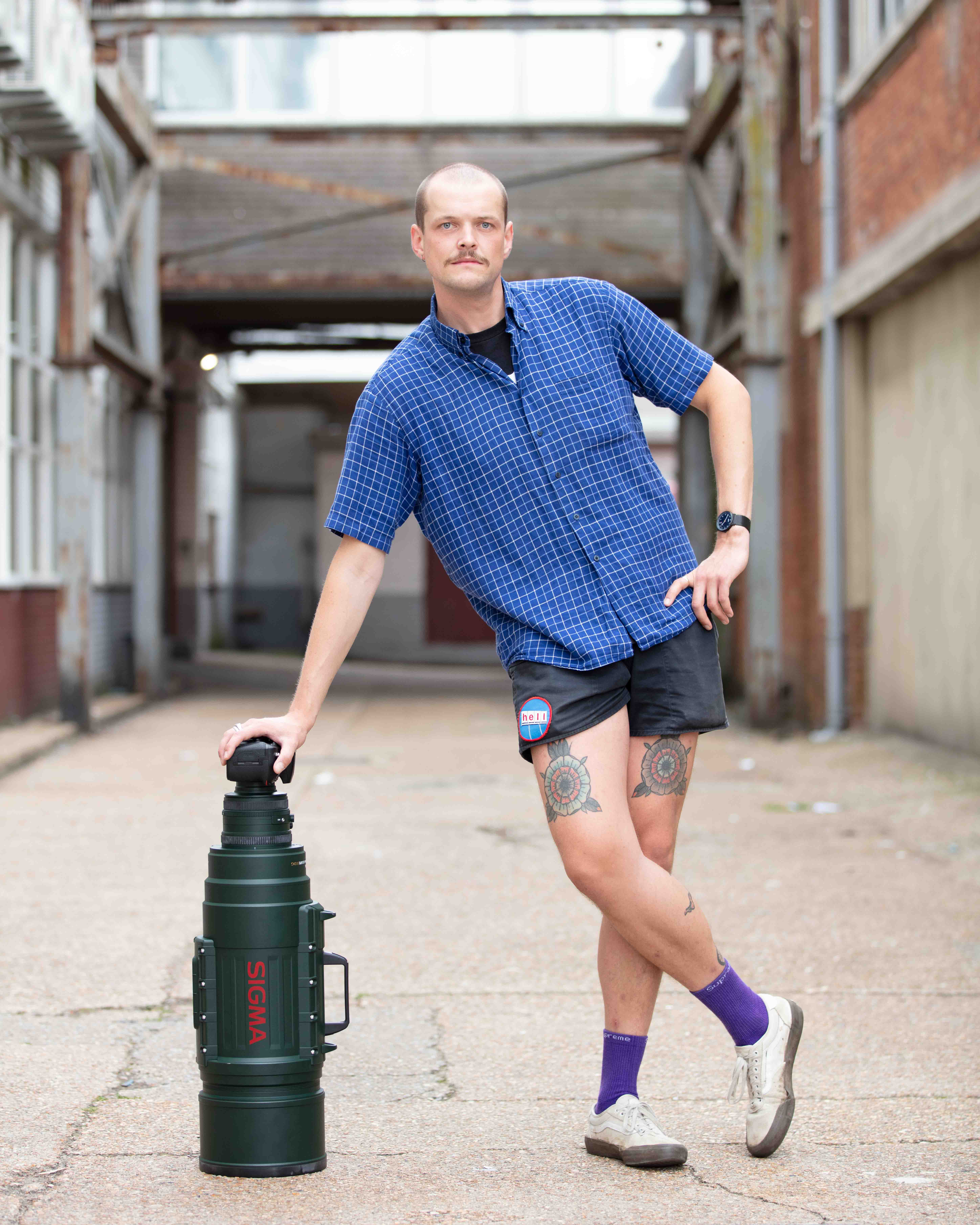 Person leaning on a large camera lens (Brighter)