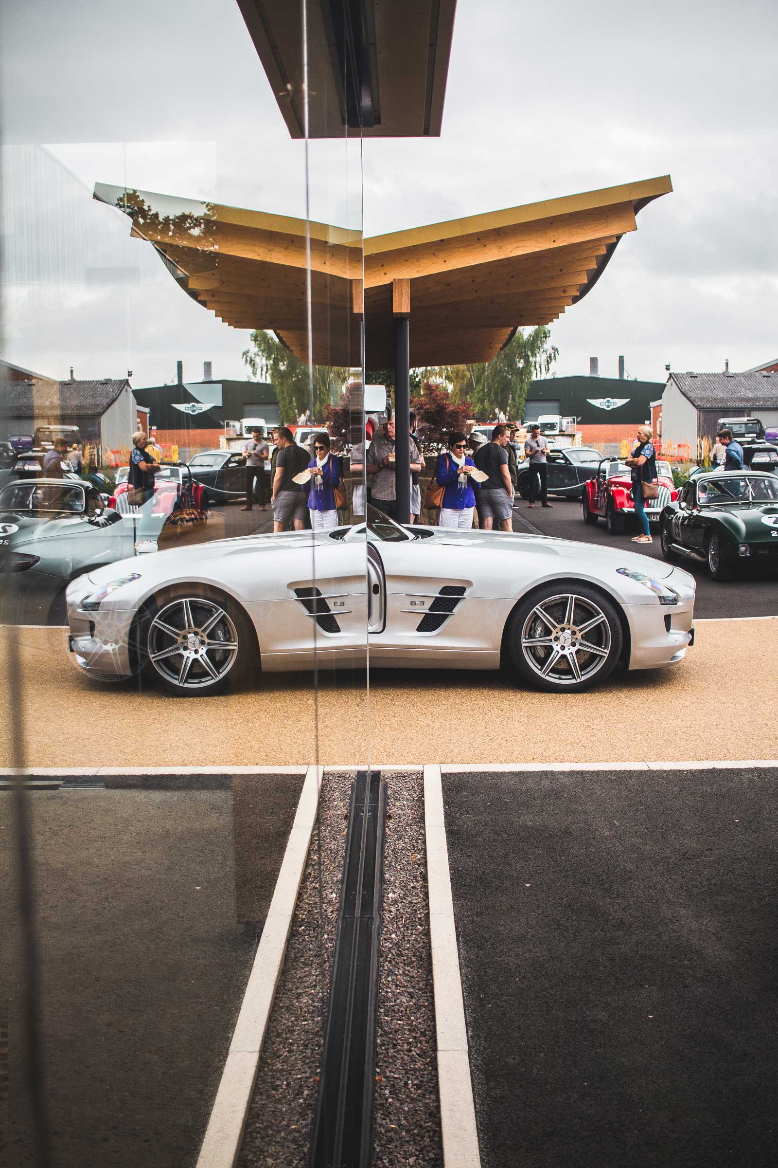 Mercedes-Benz SLS AMG half mirrored in a window