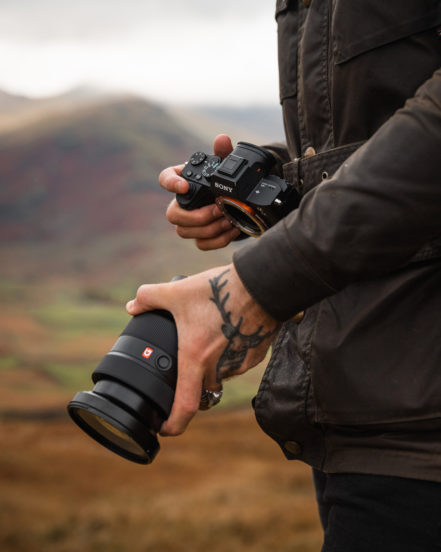 a photographer fitting a lens to a camera