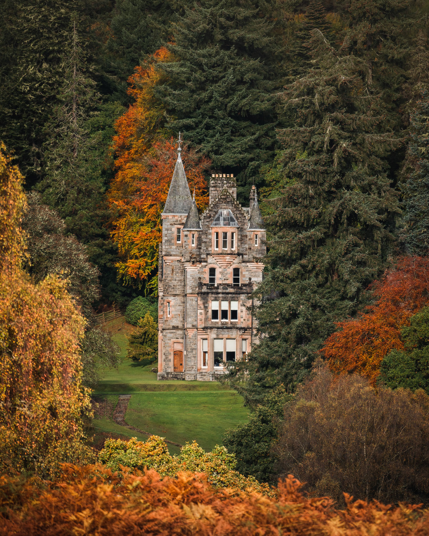 a manor house through the trees