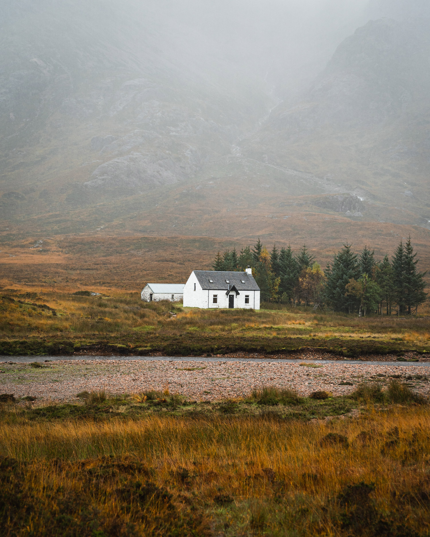 a white farmhouse in the distance 