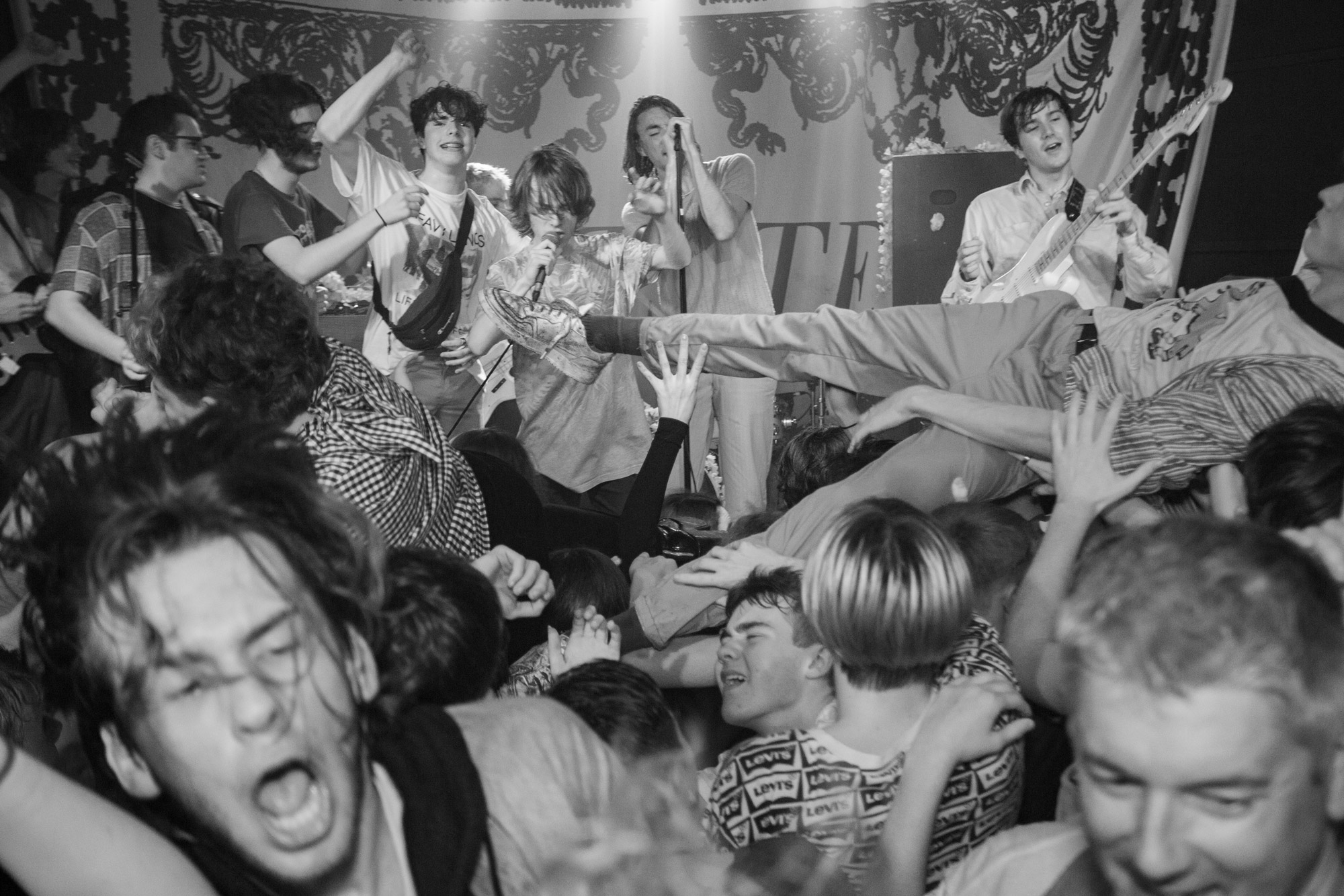 B&W photo of people dancing at a gig