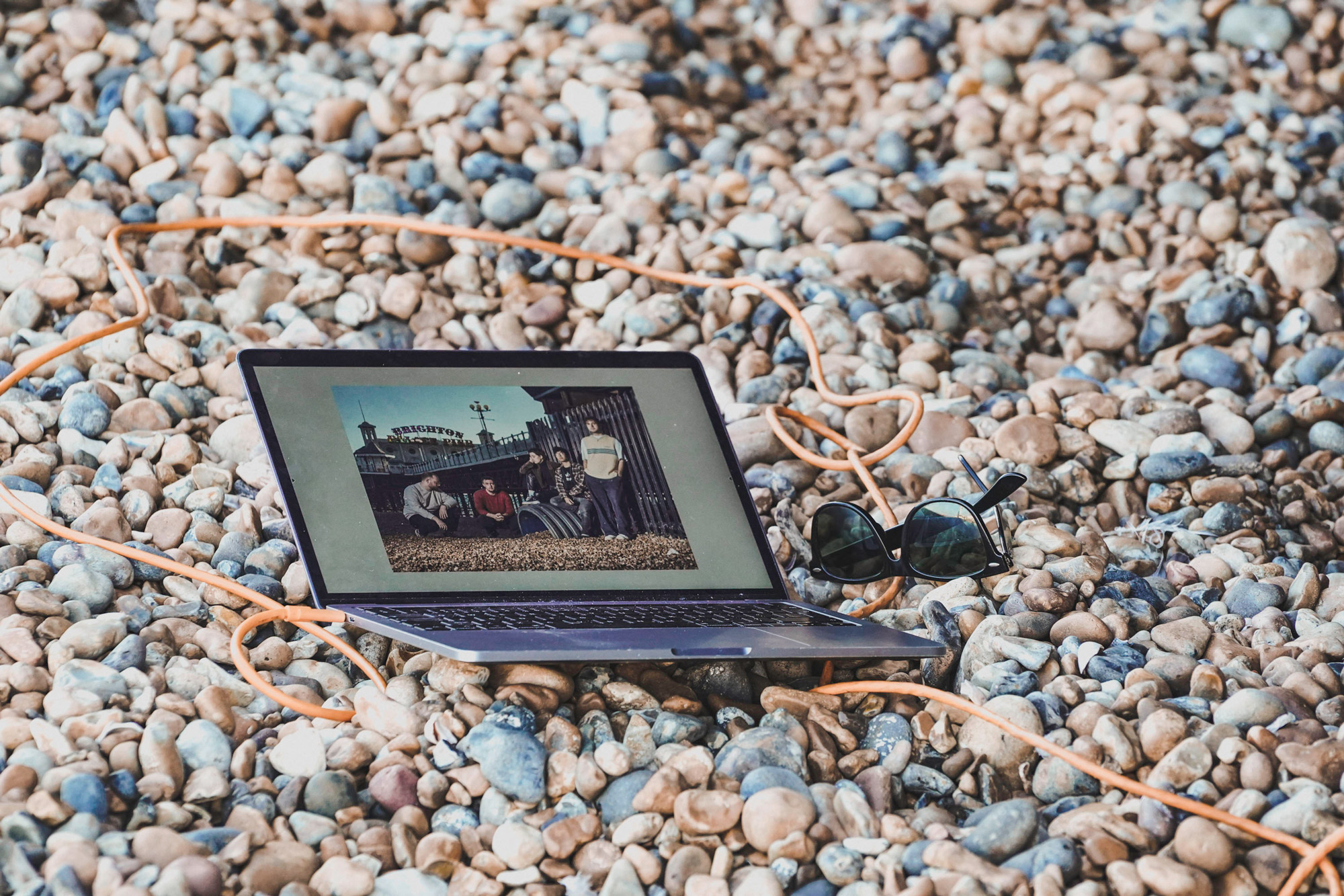 Laptop, tethered to a camera out of frame, on Brighton beach