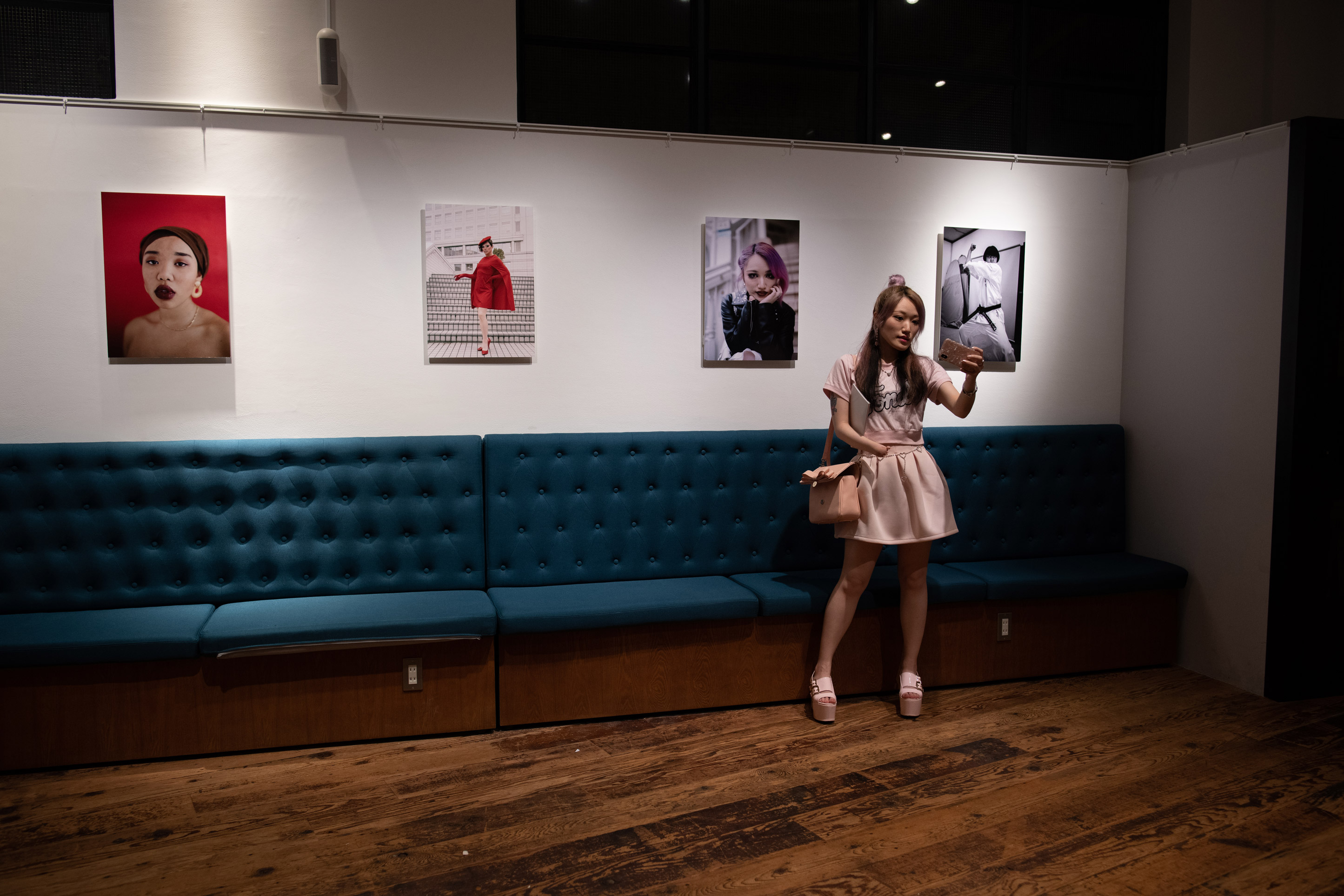 A girl taking a selfie while four images are in the background