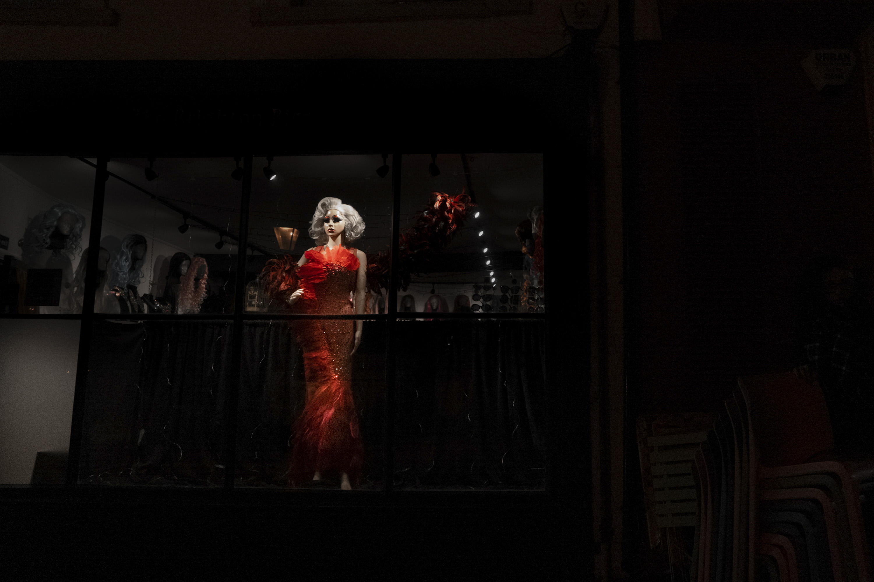 Manekin wearing a red dress at night in Brighton 