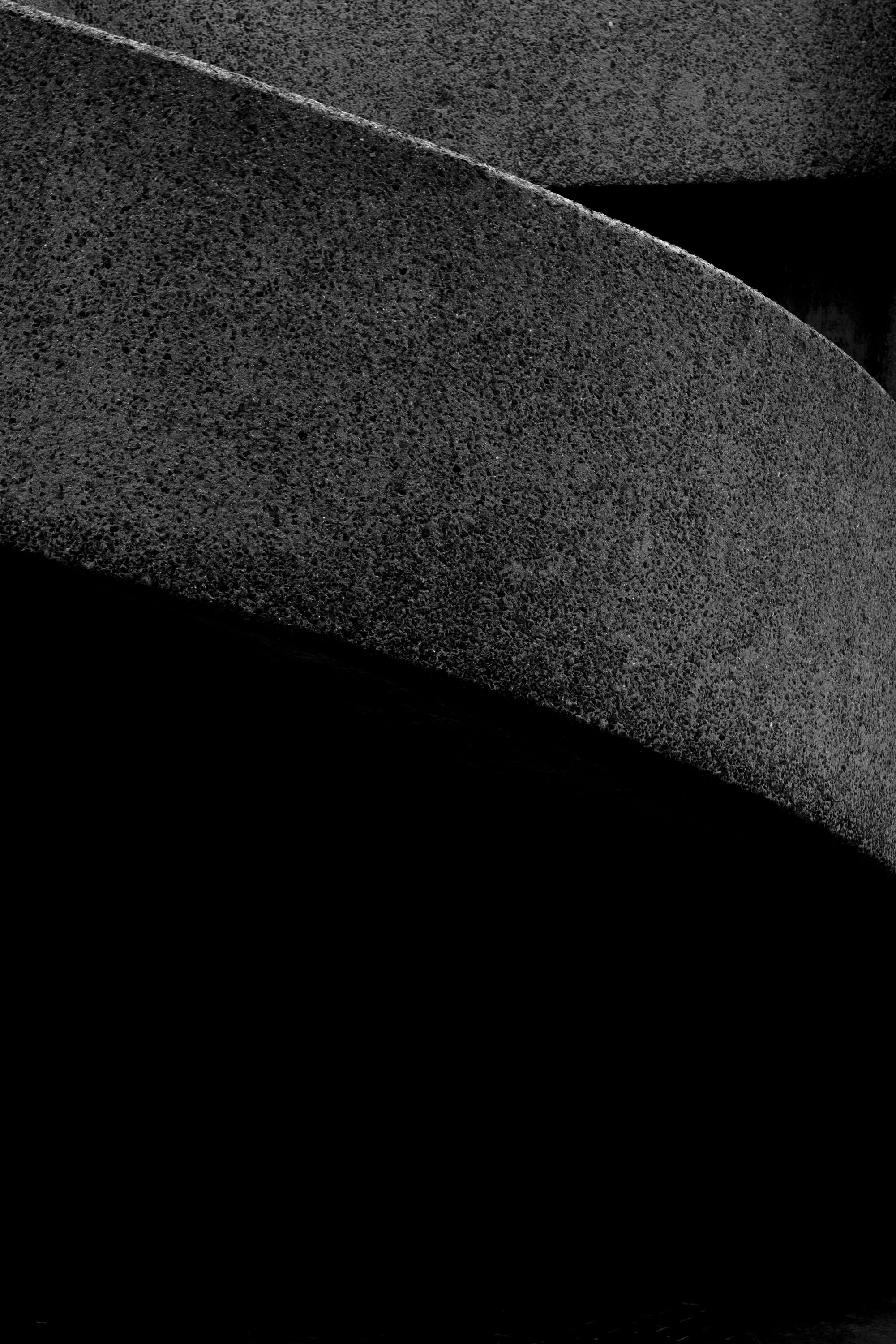 a black & white photo of a side of a building stairs