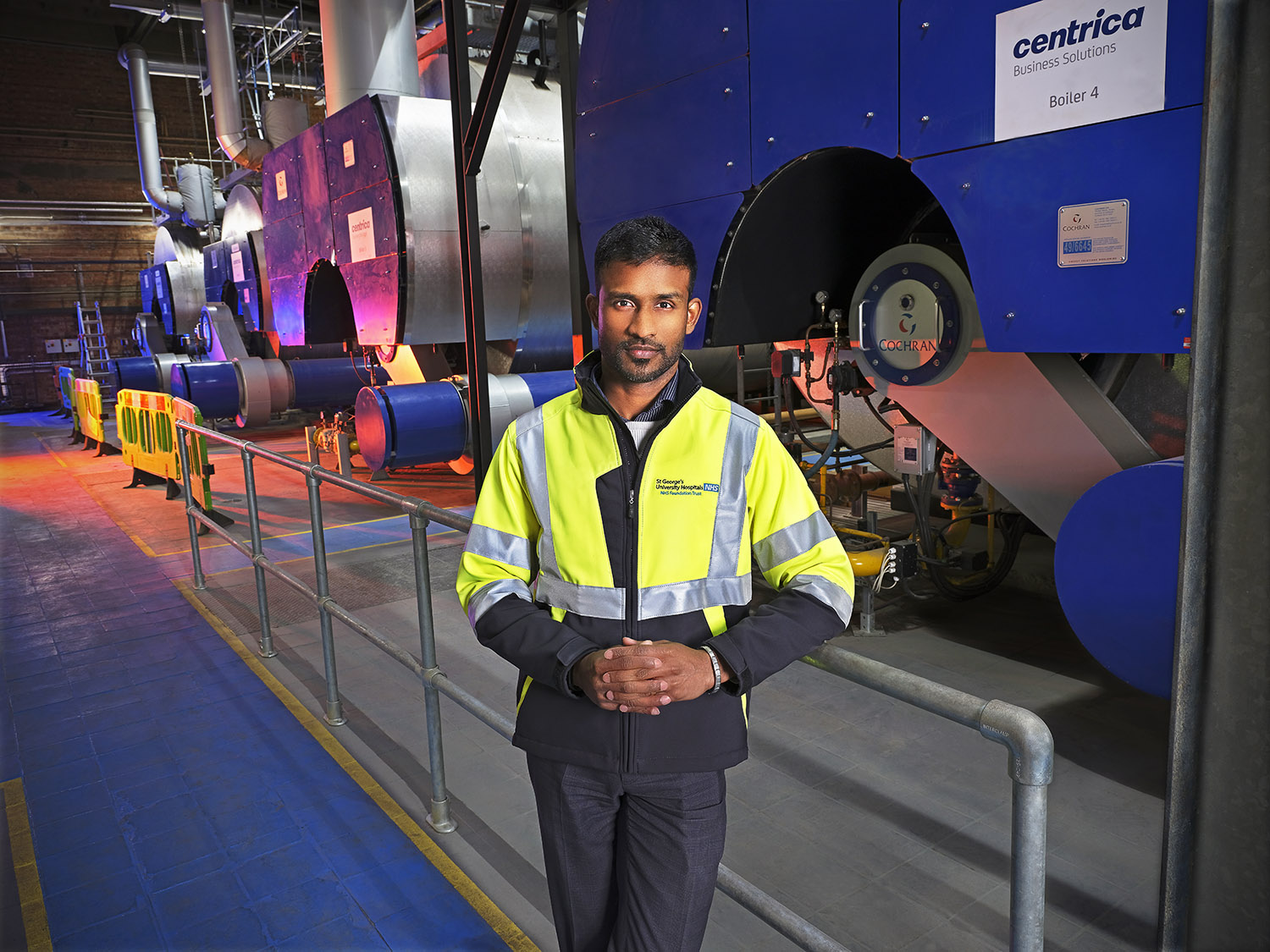 An engineer stating near underground plant machines posing for a photo