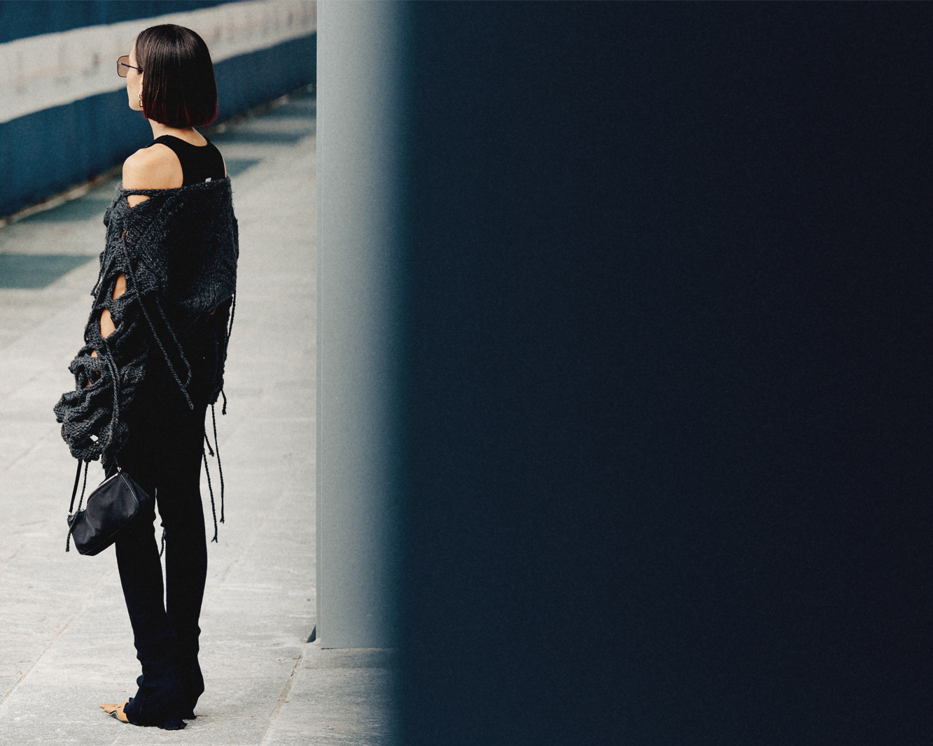 A person wearing all black waiting for someone