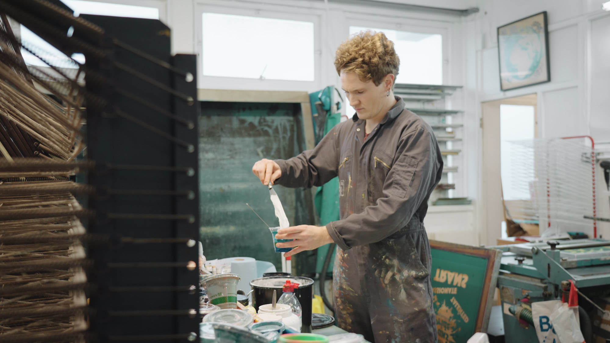 A worker mixing paint at a print company