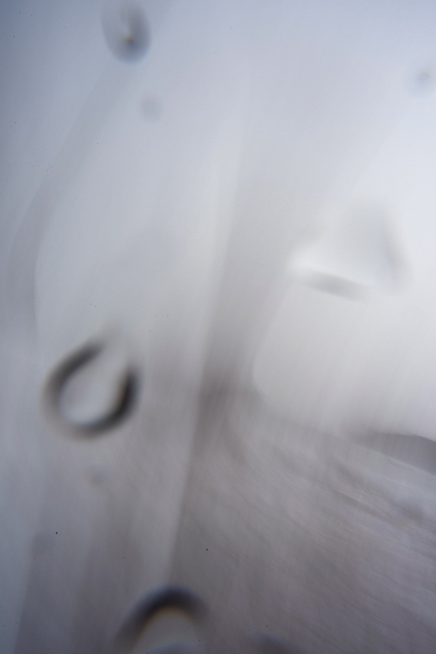 A blurry image of the sea, with water drops appearing on the lens.