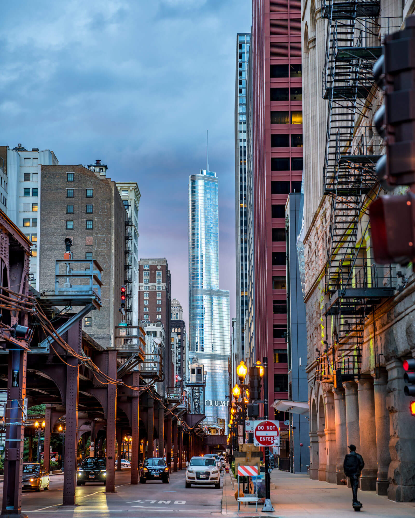 An image of a Trump tower in the distance at dusk