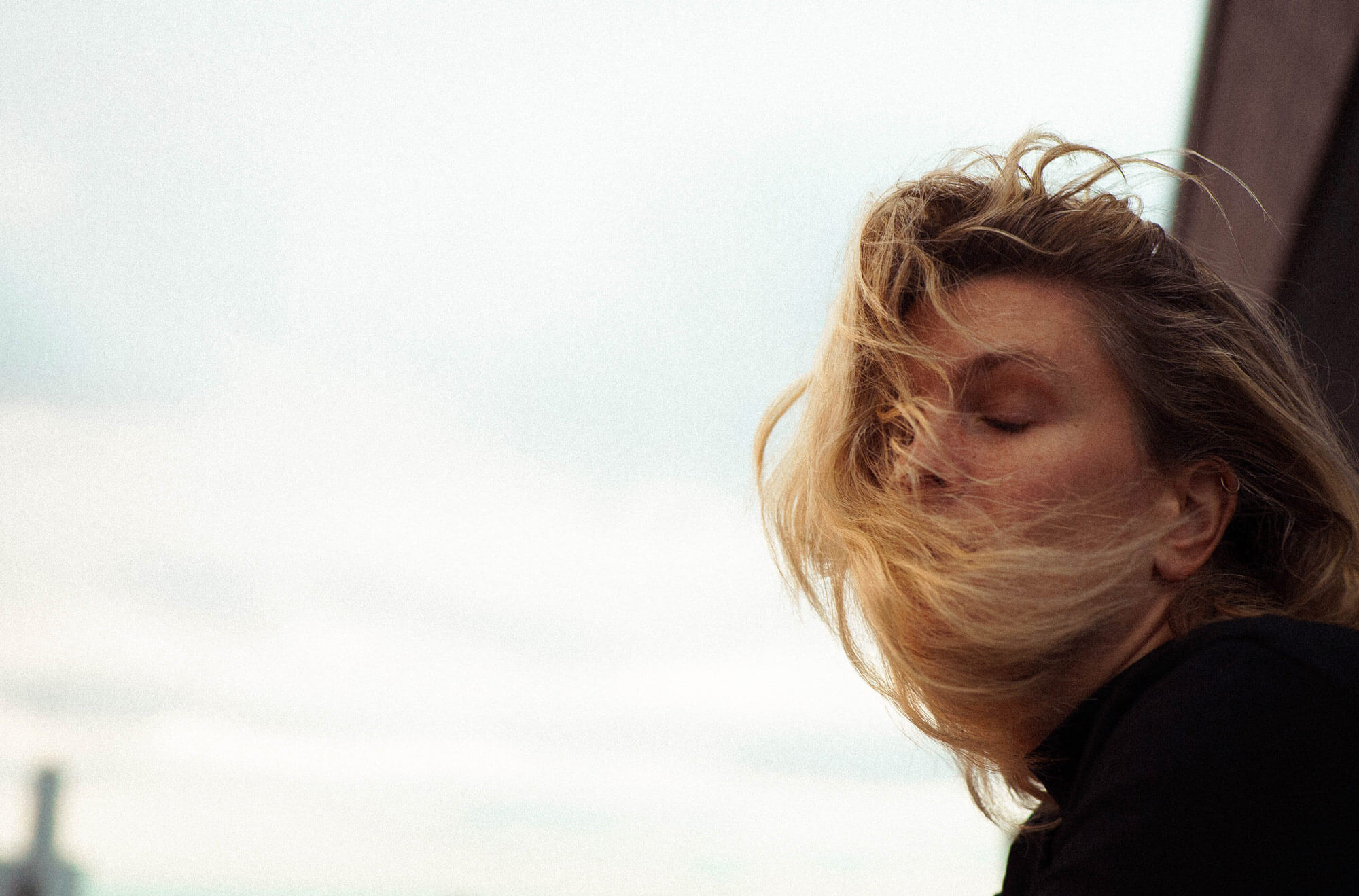 Wind blowing hair in ladies face