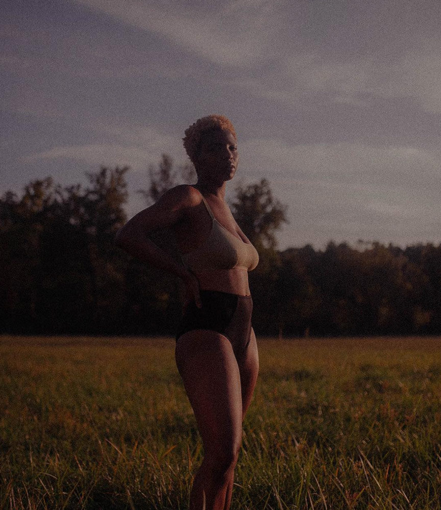 Lady outside in the dark in underwear.