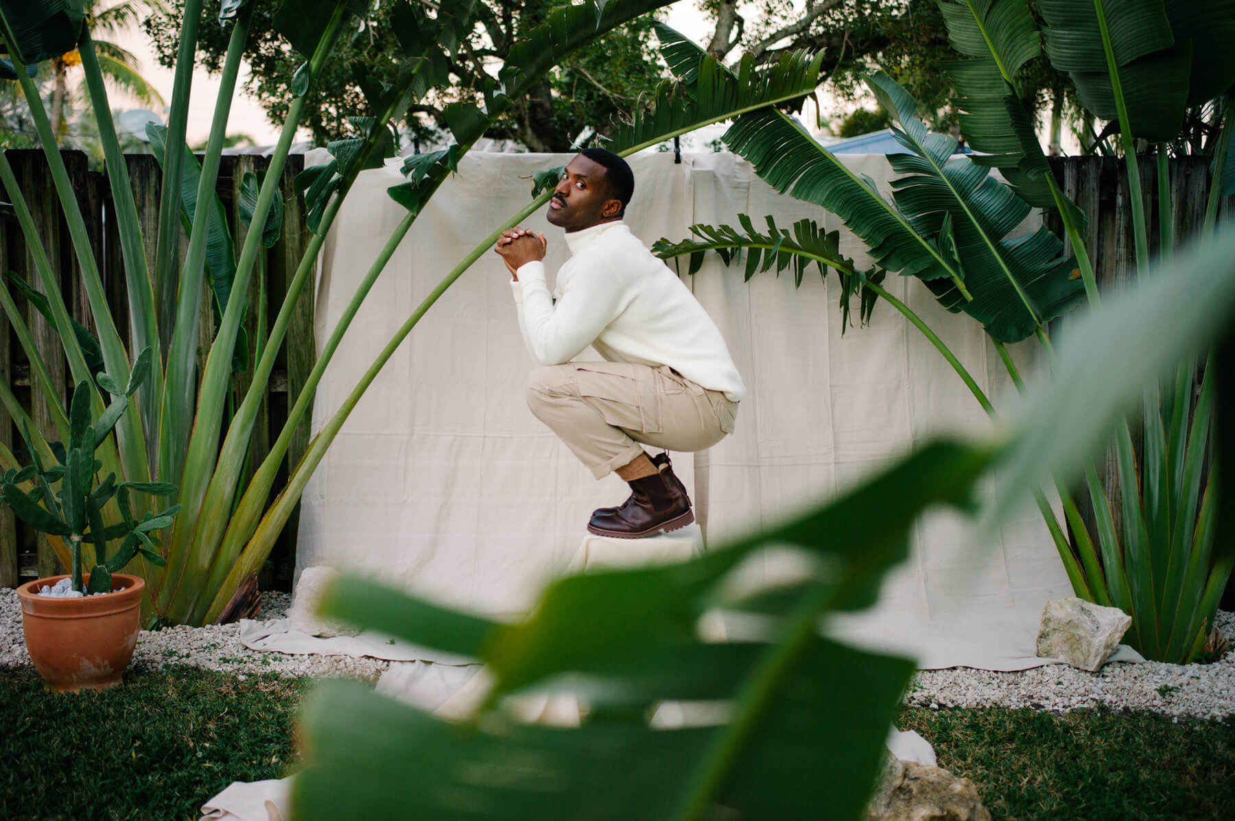 Man crouching in a garden