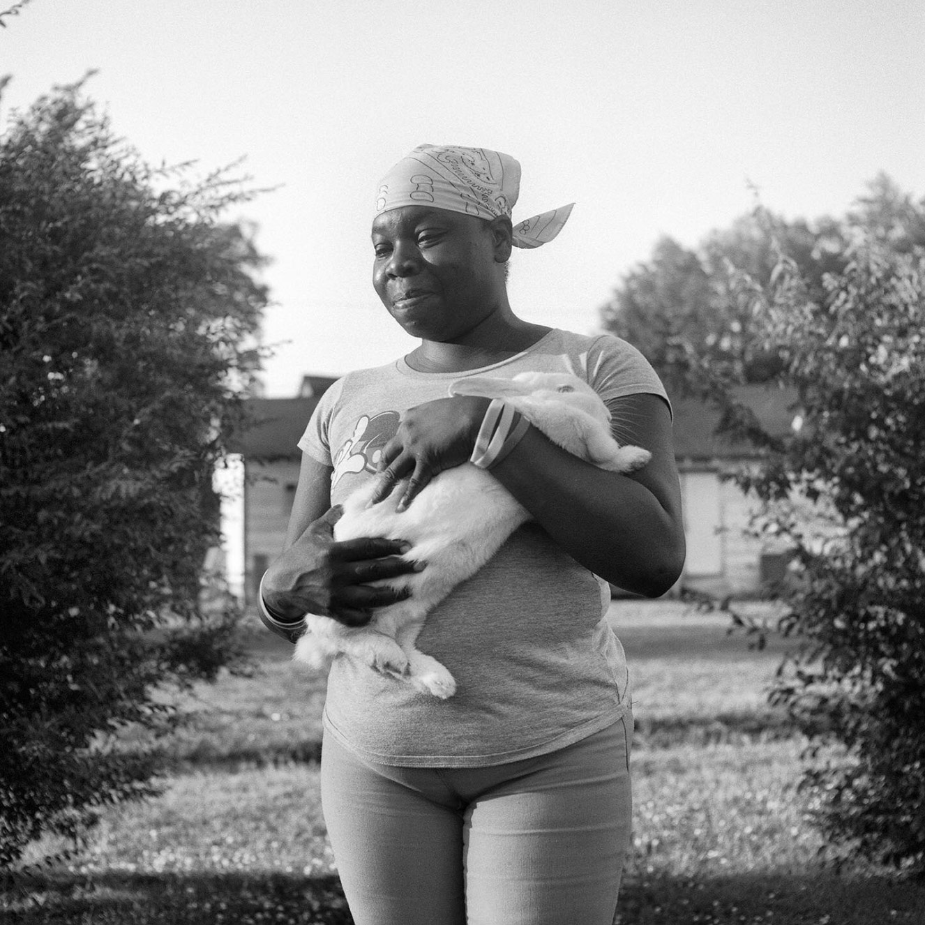 A woman holding a white bunny rabbit.