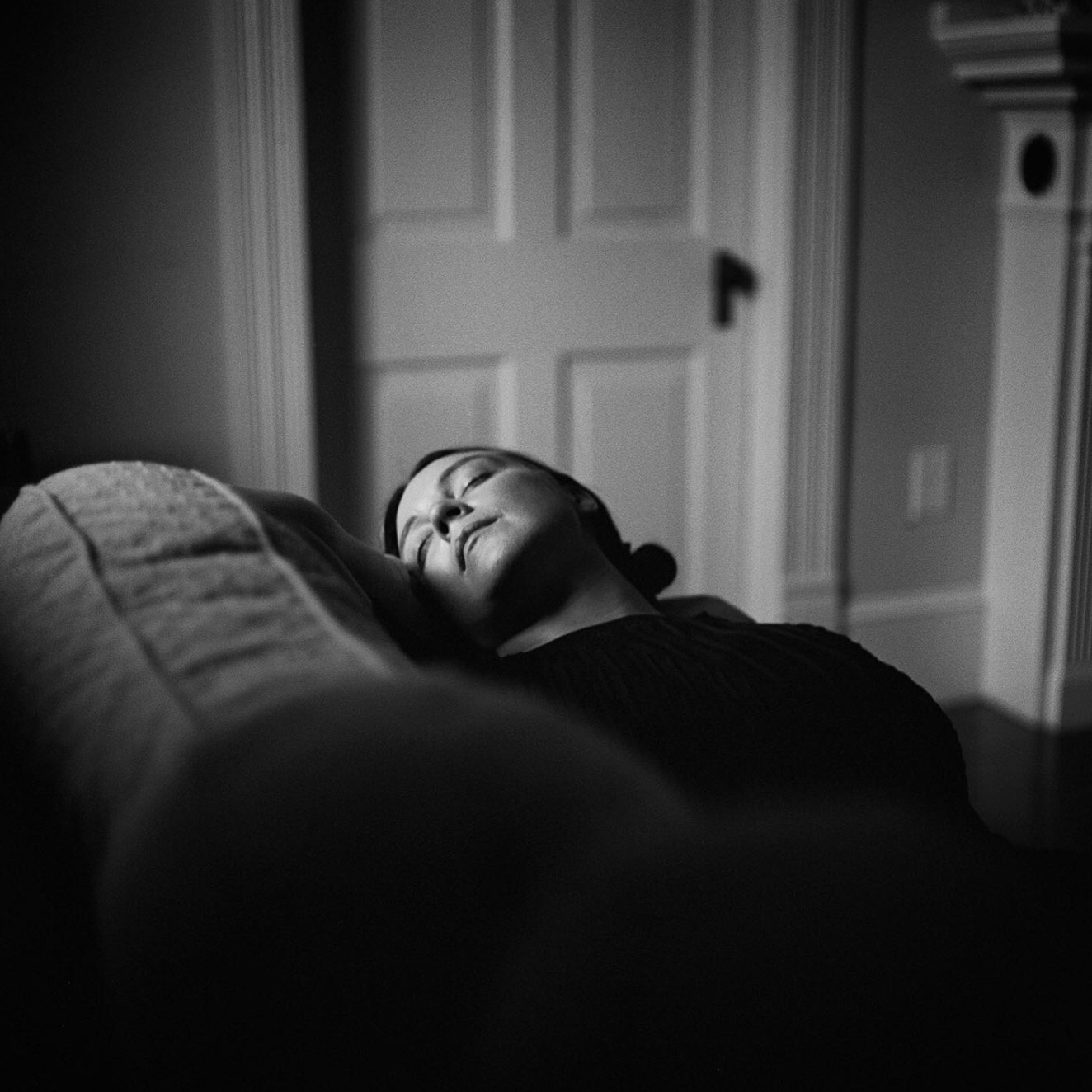 A woman resting on a couch.